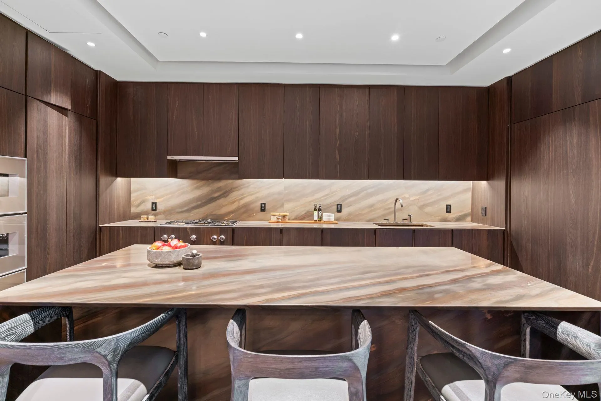 Kitchen with a sink, modern cabinets, a breakfast bar area, and dark brown cabinets Kitchen with a sink, modern cabinets, a breakfast bar area, and dark brown cabinets