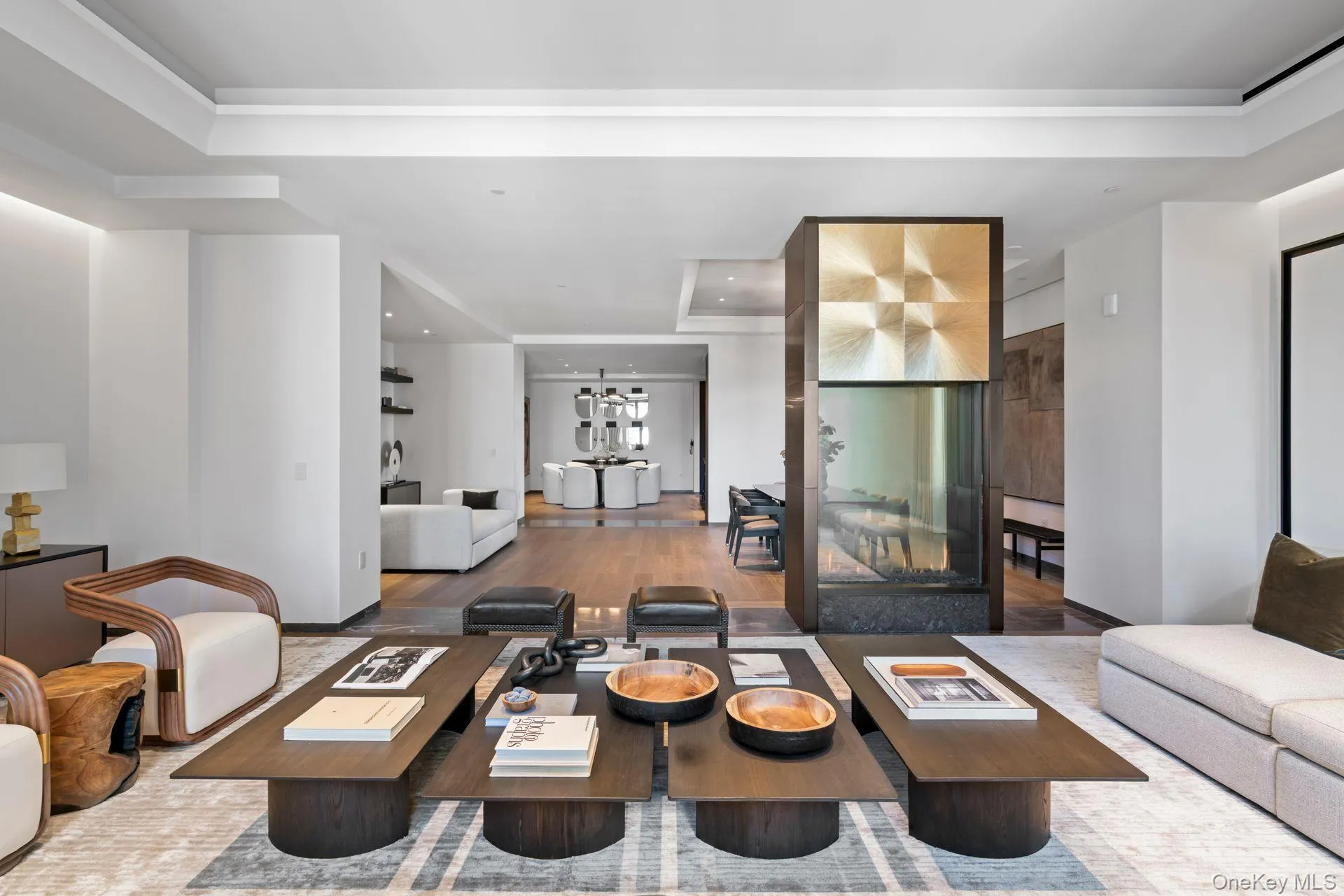 Living room with a raised ceiling, wood finished floors, and recessed lighting Living room with a raised ceiling, wood finished floors, and recessed lighting