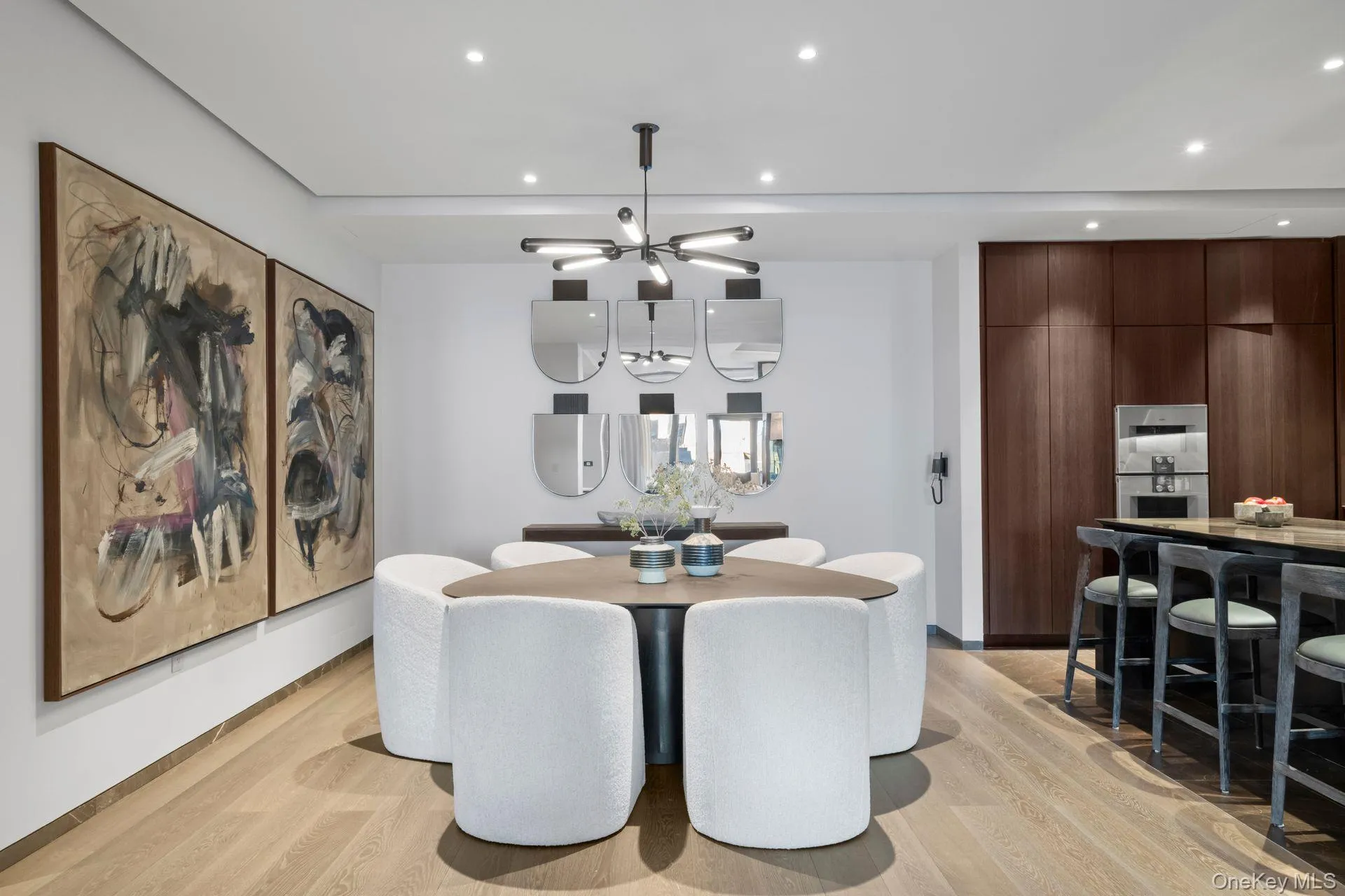 Dining area with light wood-style floors, recessed lighting, and an inviting chandelier Dining area with light wood-style floors, recessed lighting, and an inviting chandelier