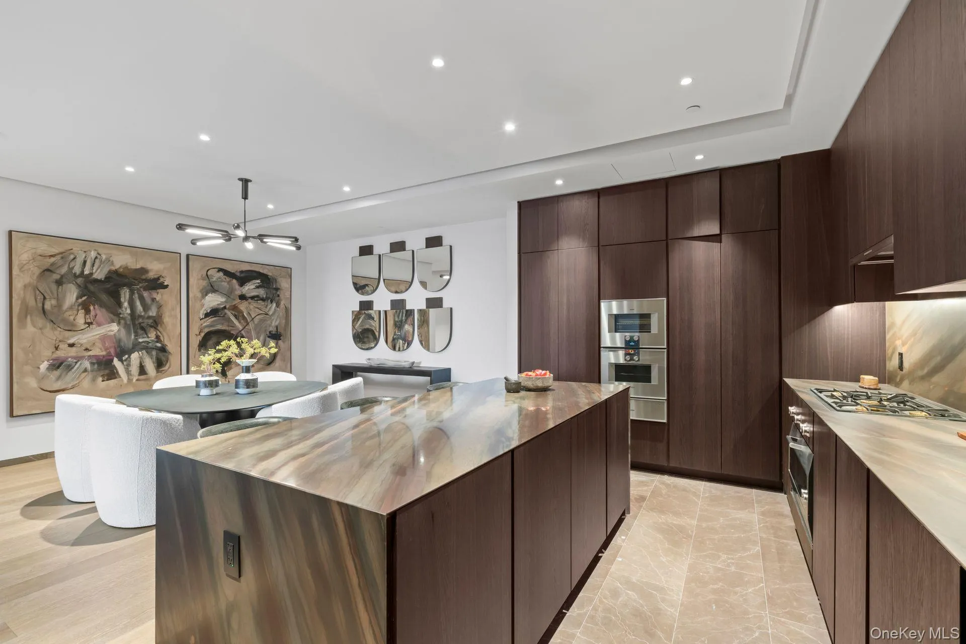 Kitchen with dark brown cabinetry, modern cabinets, a kitchen island, and recessed lighting Kitchen with dark brown cabinetry, modern cabinets, a kitchen island, and recessed lighting