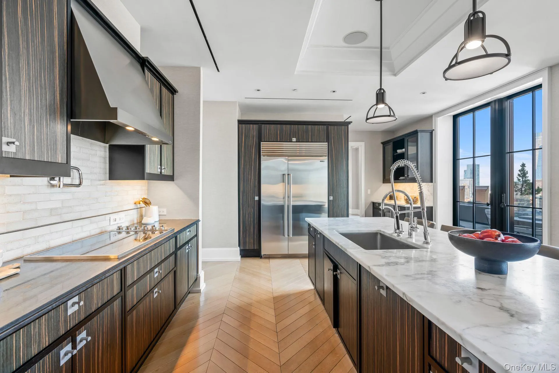 Kitchen with black electric cooktop, a sink, ventilation hood, stainless steel built in fridge, and backsplash Kitchen with black electric cooktop, a sink, ventilation hood, stainless steel built in fridge, and backsplash