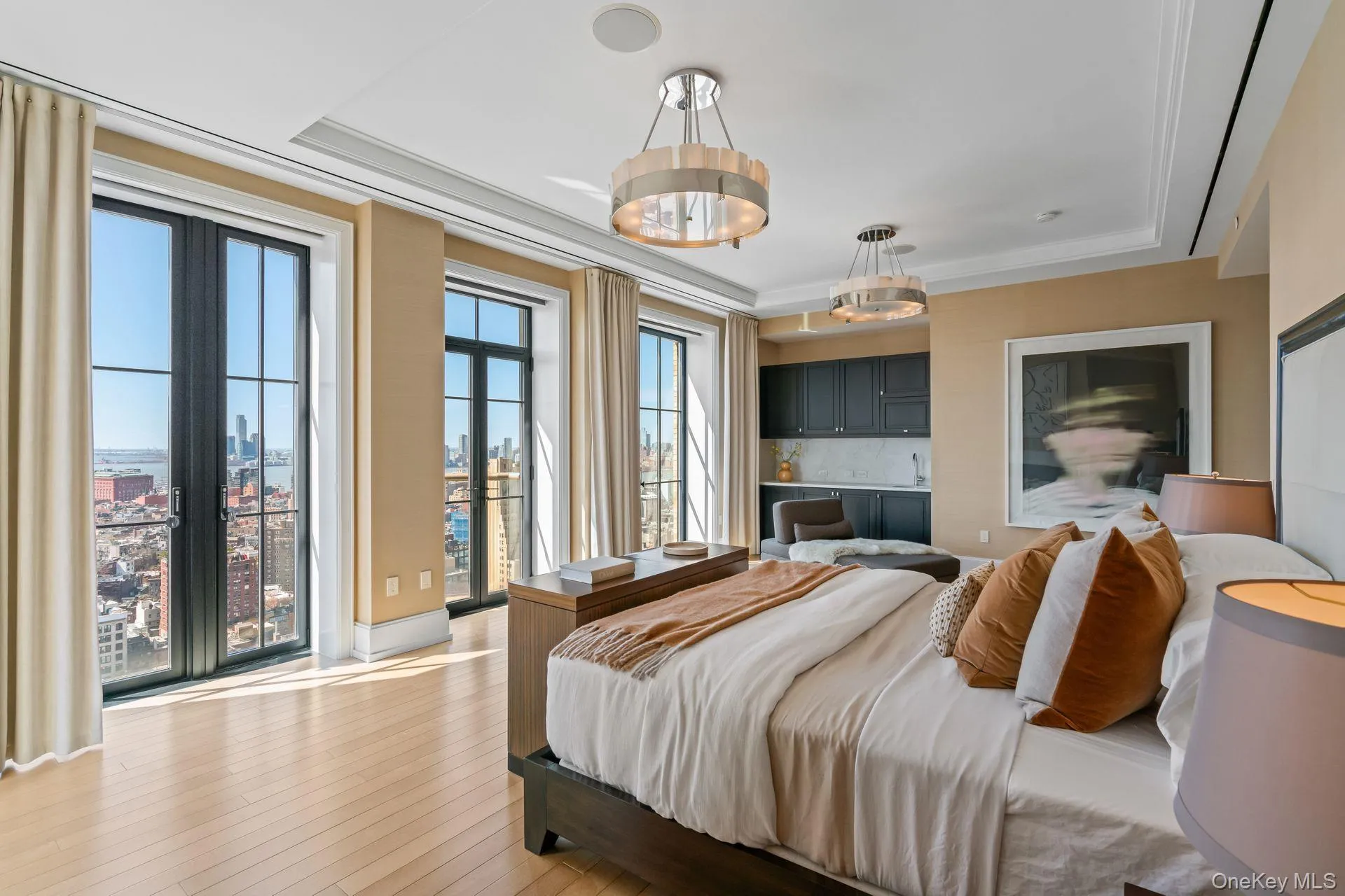 Bedroom featuring access to outside, light wood-style floors, crown molding, and a raised ceiling Bedroom featuring access to outside, light wood-style floors, crown molding, and a raised ceiling
