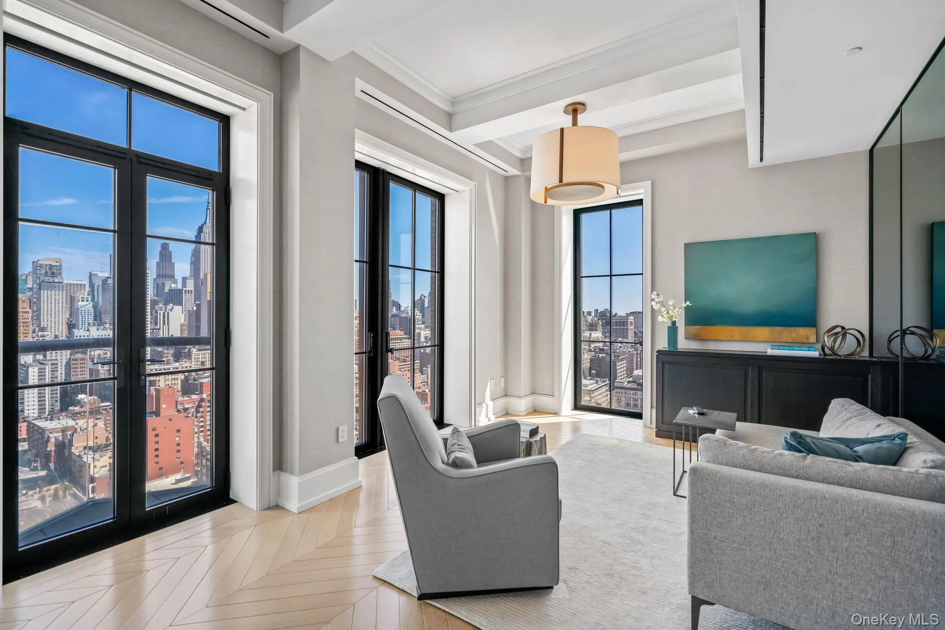 Living area with a city view, baseboards, beamed ceiling, and ornamental molding Living area with a city view, baseboards, beamed ceiling, and ornamental molding