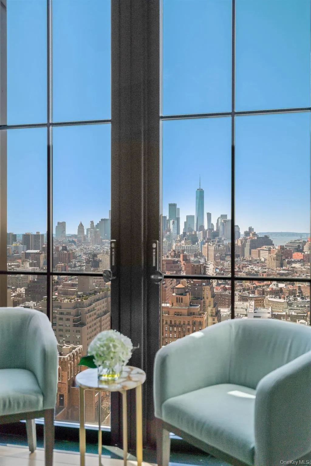 Sitting room with floor to ceiling windows, plenty of natural light, and a city view Sitting room with floor to ceiling windows, plenty of natural light, and a city view