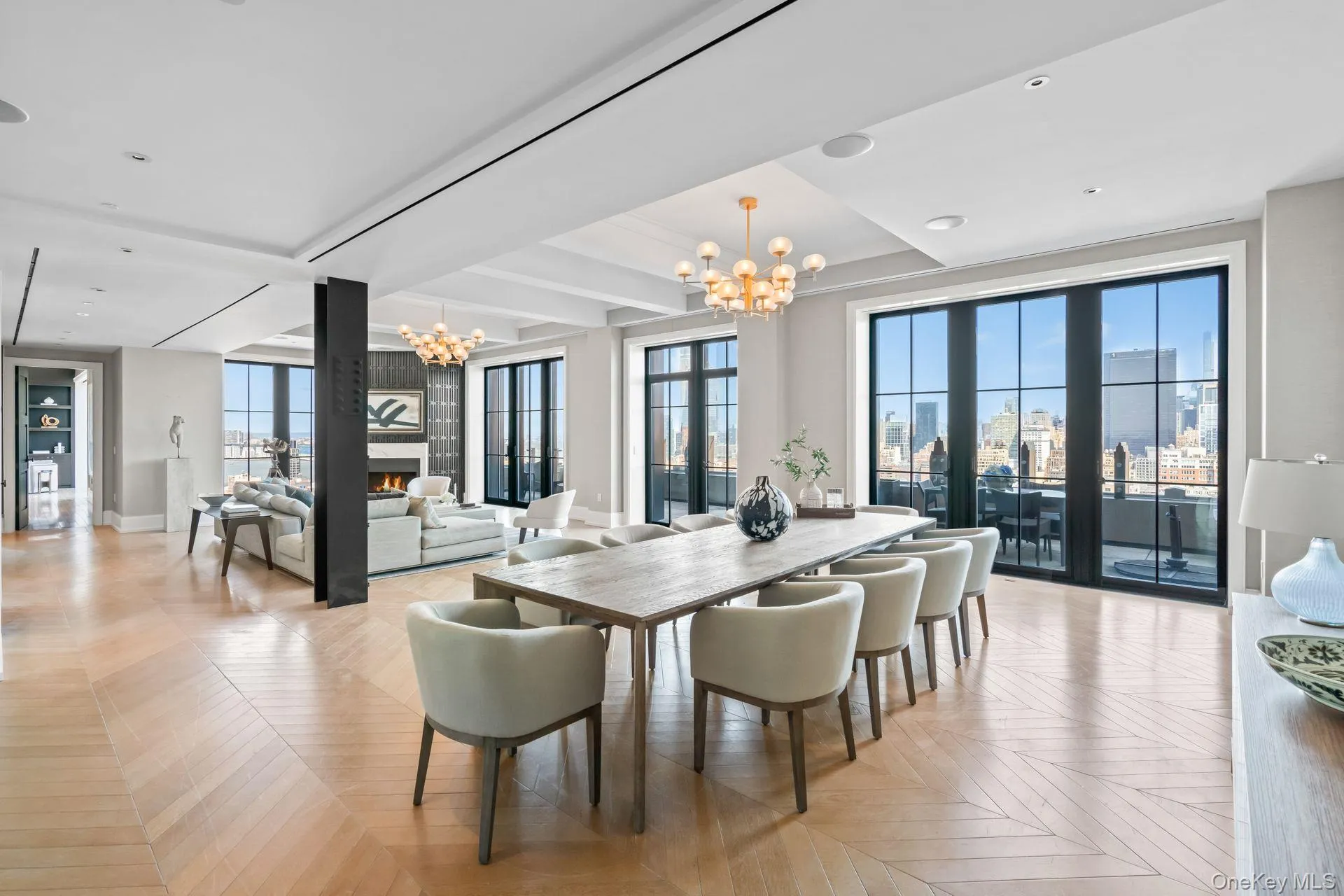 Dining area featuring baseboards, a view of city, a fireplace, and an inviting chandelier Dining area featuring baseboards, a view of city, a fireplace, and an inviting chandelier