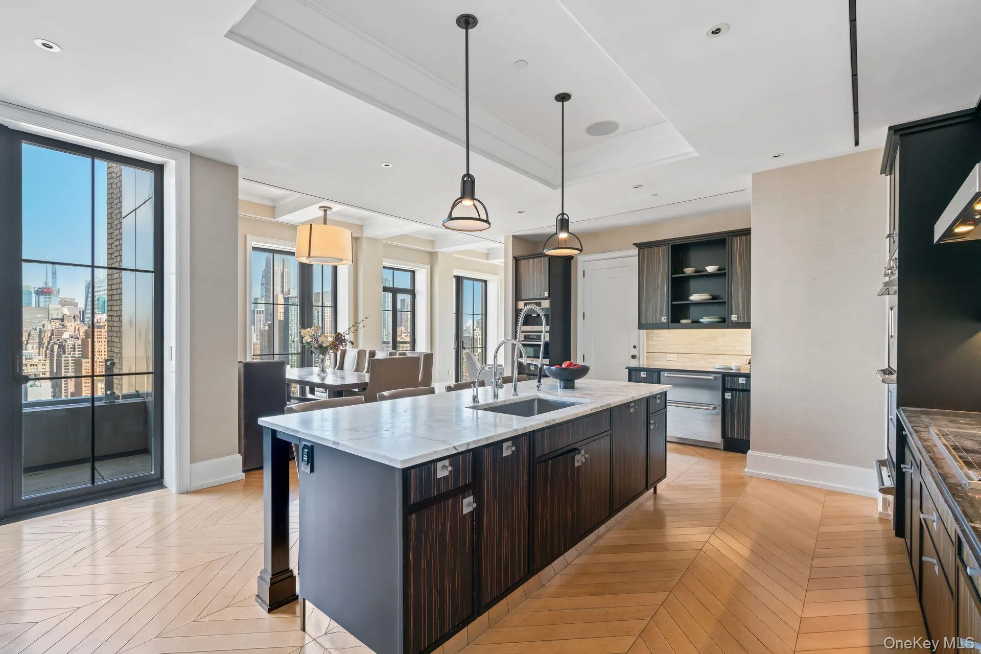 Kitchen with backsplash, open shelves, a sink, a raised ceiling, and a kitchen island with sink Kitchen with backsplash, open shelves, a sink, a raised ceiling, and a kitchen island with sink