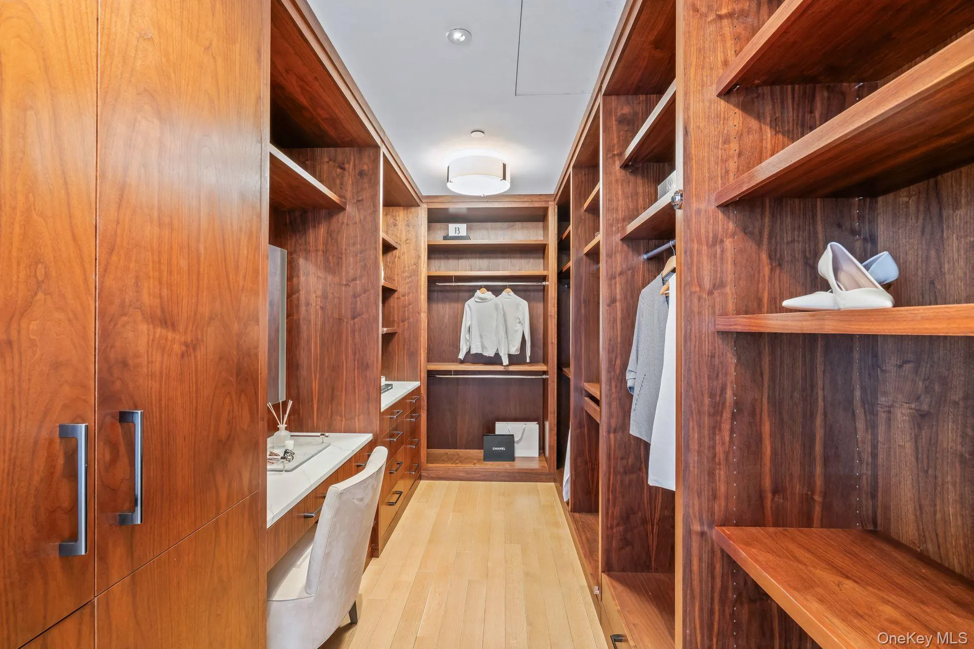 Spacious closet with light wood-style floors Spacious closet with light wood-style floors