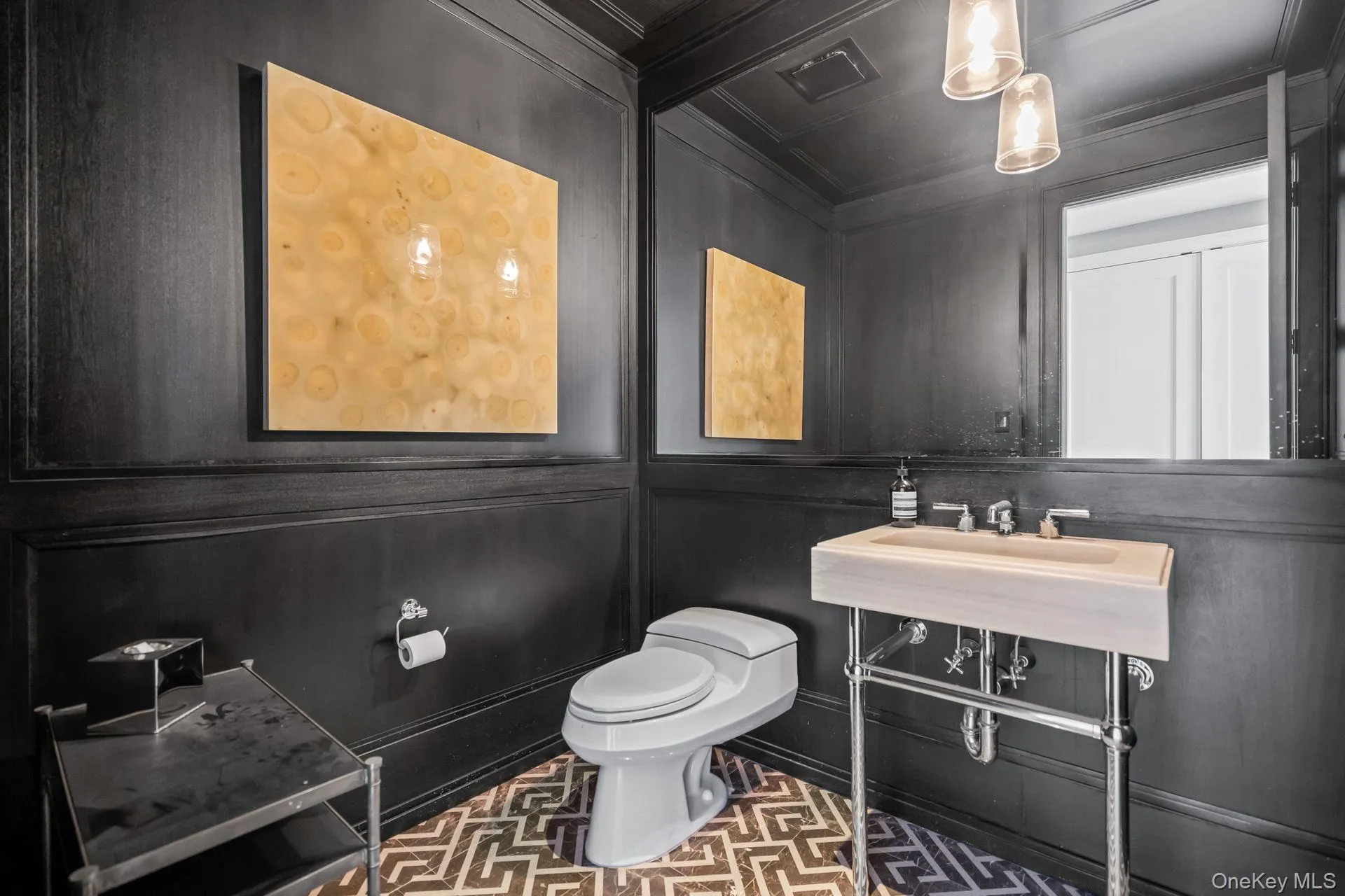 Half bath with a decorative wall, toilet, and crown molding Half bath with a decorative wall, toilet, and crown molding