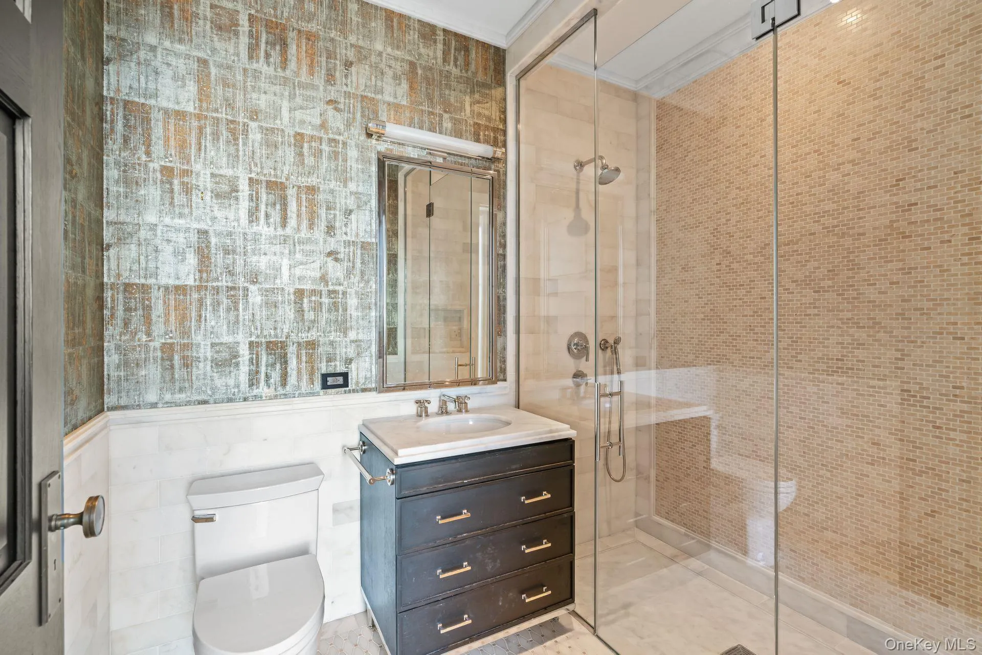 Bathroom with vanity, crown molding, tile walls, toilet, and a stall shower Bathroom with vanity, crown molding, tile walls, toilet, and a stall shower