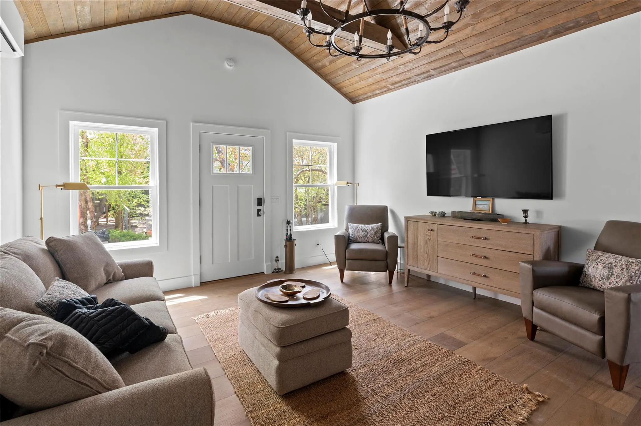 Living area featuring wood ceiling, a chandelier, lofted ceiling, and wood-type flooring Living area featuring wood ceiling, a chandelier, lofted ceiling, and wood-type flooring