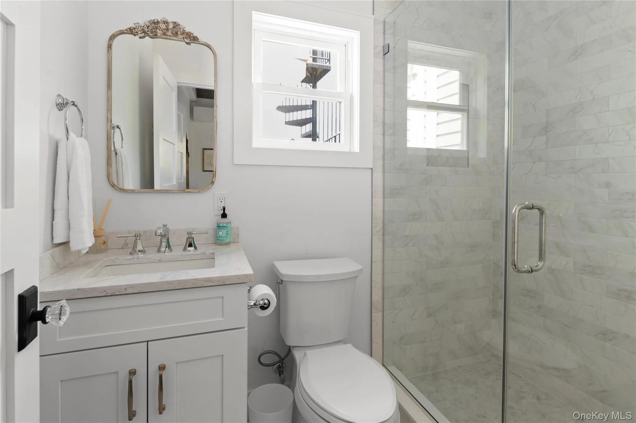 Bathroom with a shower stall, vanity, and toilet Bathroom with a shower stall, vanity, and toilet