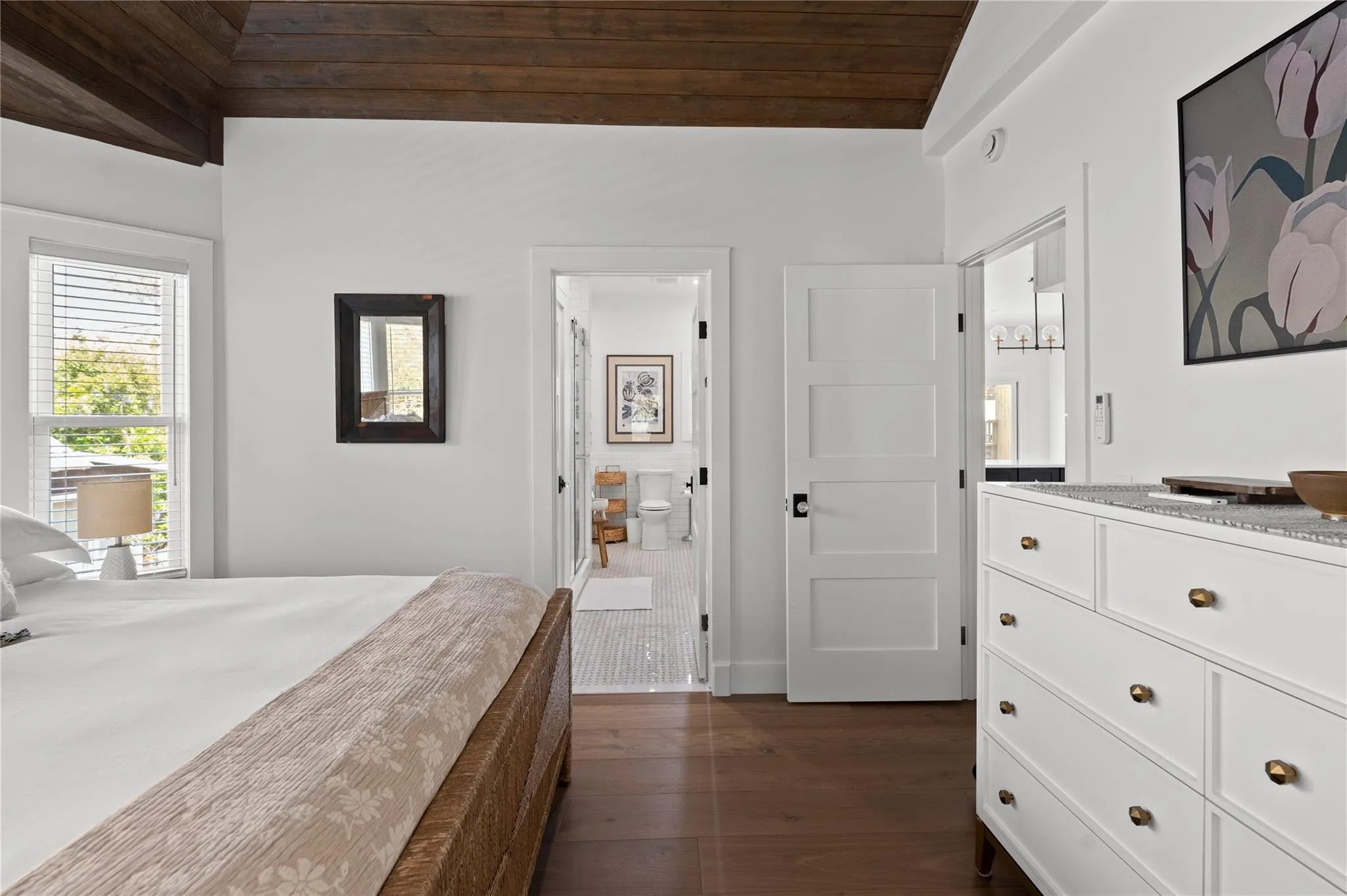 Bedroom featuring dark wood-type flooring, vaulted ceiling, wooden ceiling, and ensuite bathroom Bedroom featuring dark wood-type flooring, vaulted ceiling, wooden ceiling, and ensuite bathroom