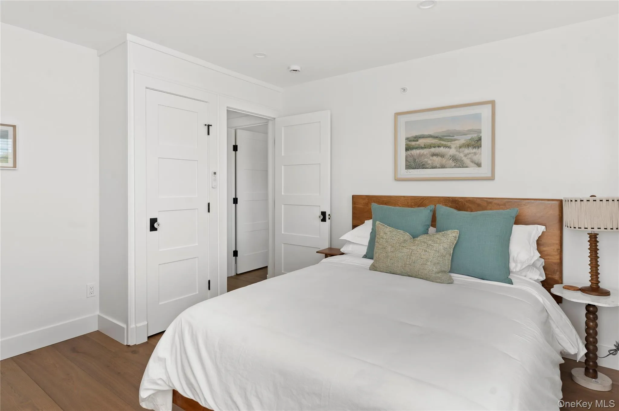 Bedroom featuring dark wood-type flooring and baseboards Bedroom featuring dark wood-type flooring and baseboards