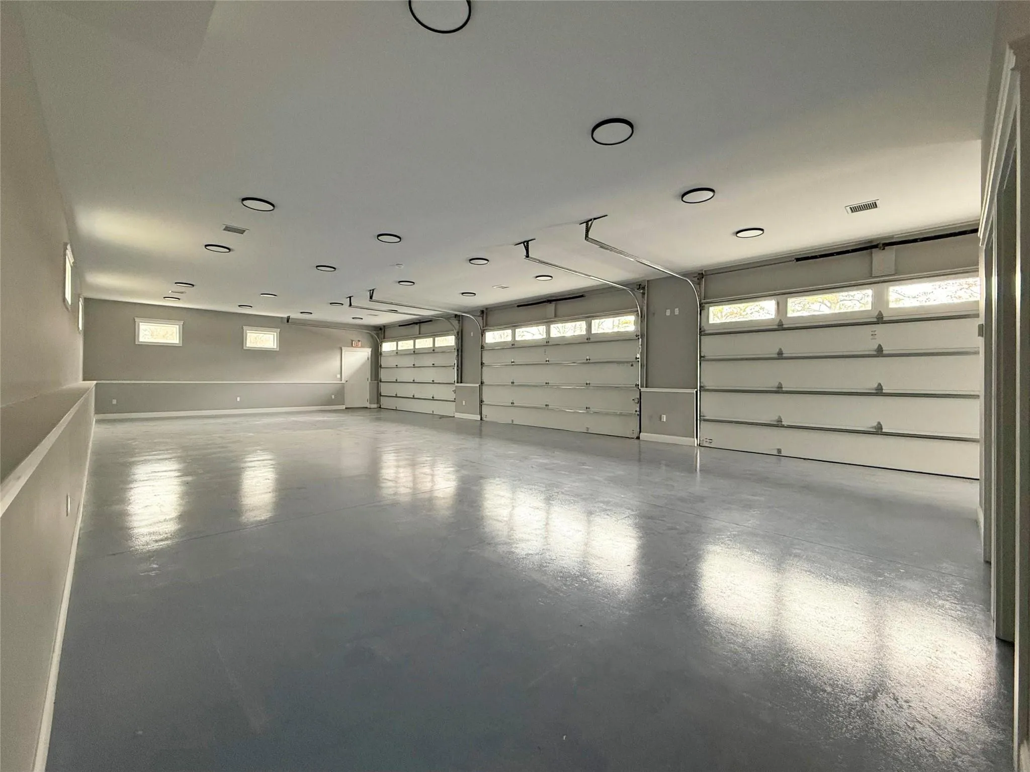 View of garage with 3 Overhead Doors View of garage with 3 Overhead Doors