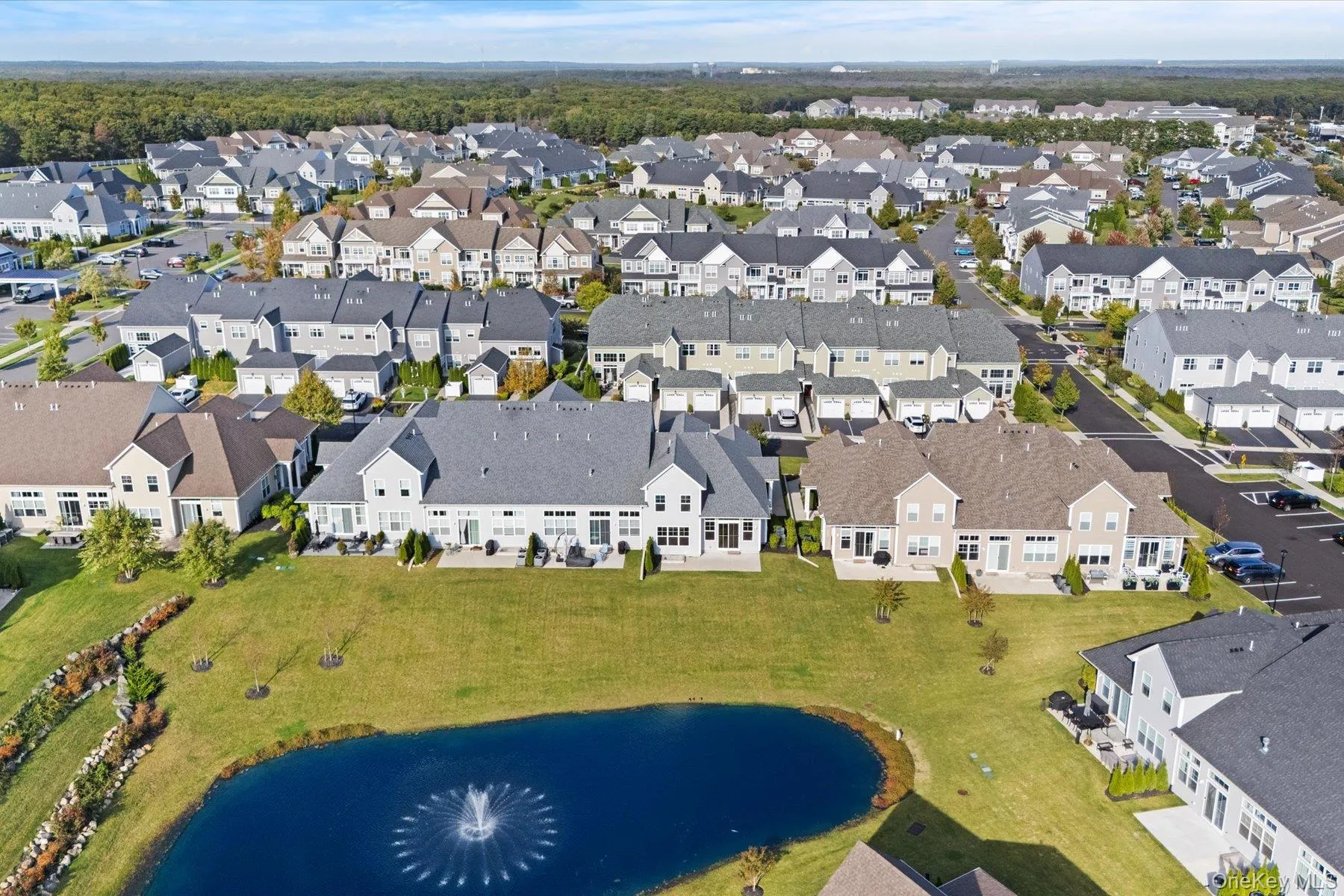 Aerial view of property's location featuring a large body of water and nearby suburban area Aerial view of property's location featuring a large body of water and nearby suburban area