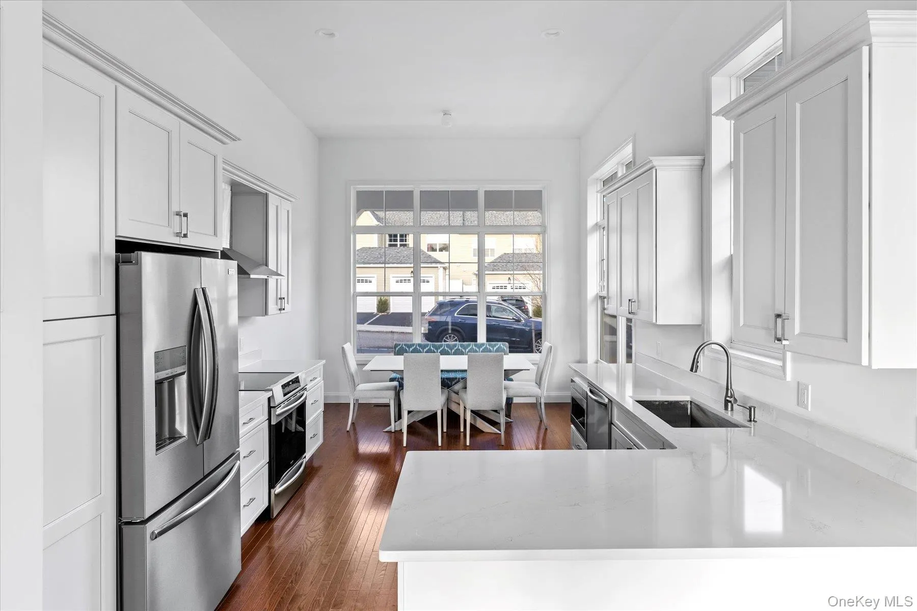 Kitchen featuring stainless steel appliances, kitchen peninsula, white cabinets Kitchen featuring stainless steel appliances, kitchen peninsula, white cabinets