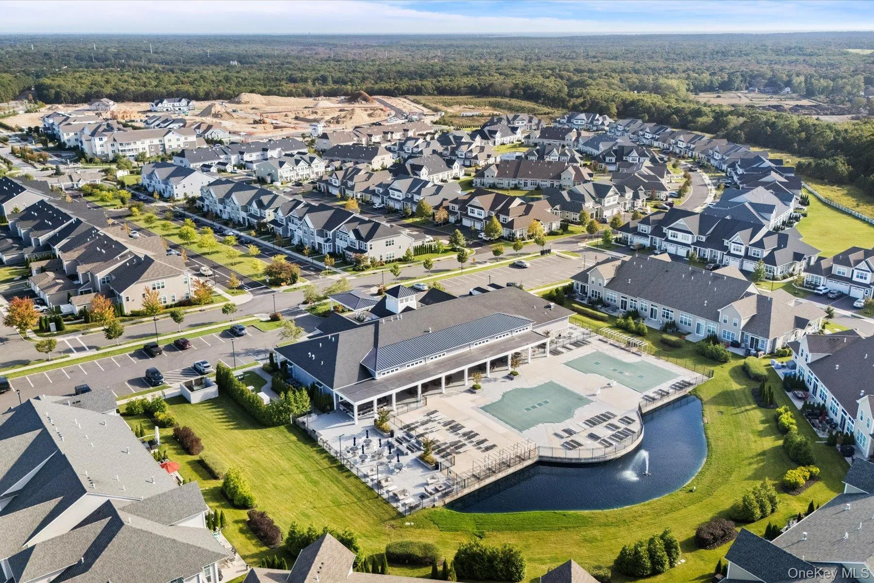 Aerial view of property and surrounding area featuring nearby suburban area Aerial view of property and surrounding area featuring nearby suburban area
