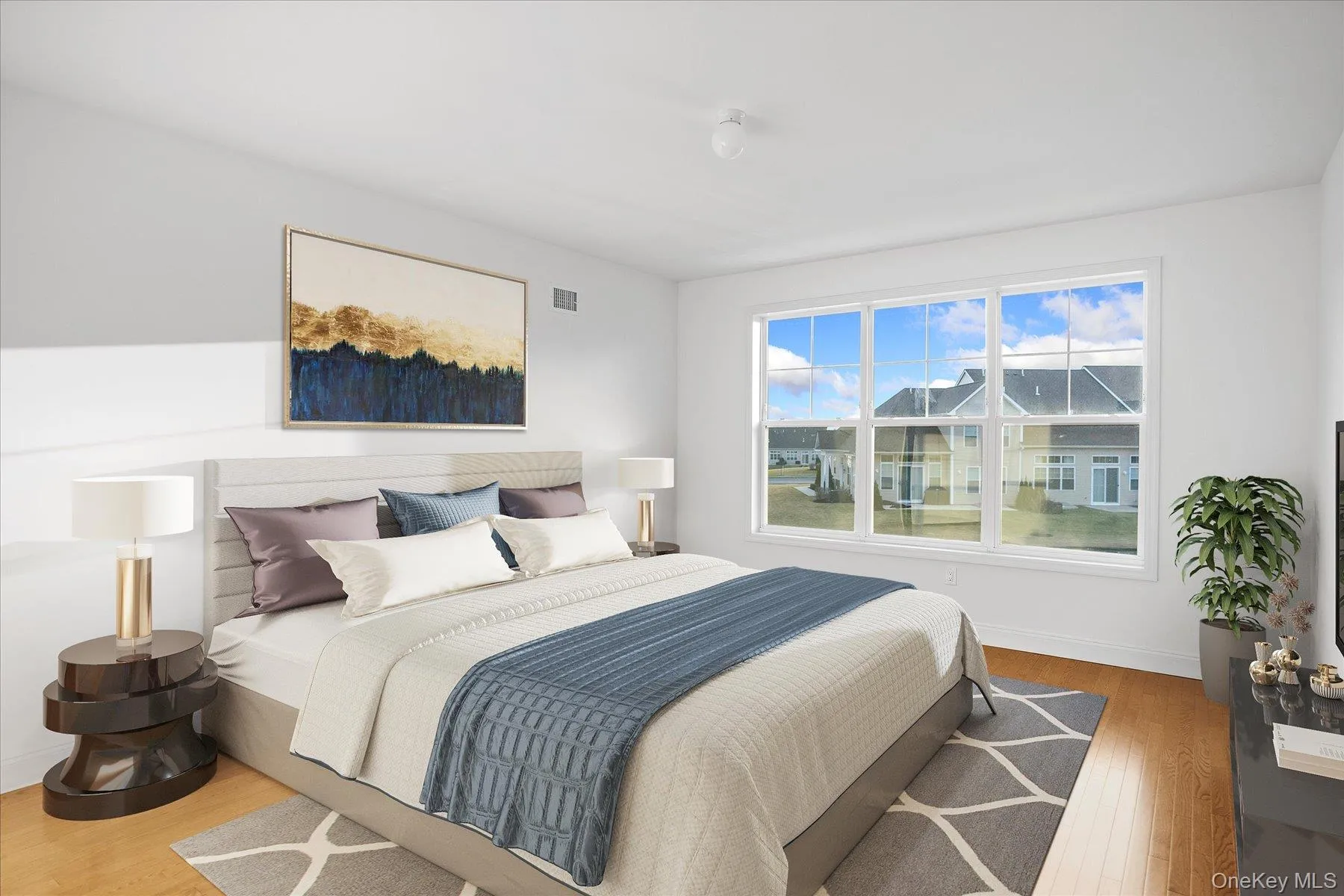 (Virtually staged) Spacious primary bedroom with hardwood flooring (Virtually staged) Spacious primary bedroom with hardwood flooring