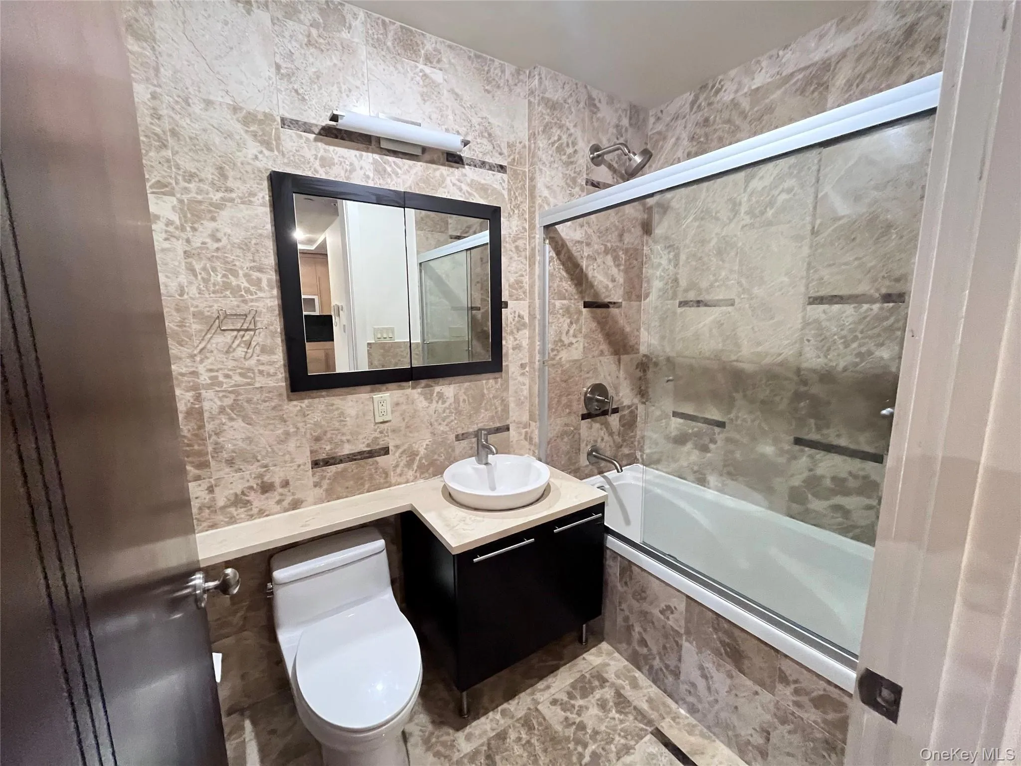 Full bathroom featuring in marble finishes. Full bathroom featuring in marble finishes.