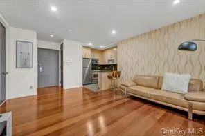 Living room & open kitchen with stainless steel appliances & island top Living room & open kitchen with stainless steel appliances & island top