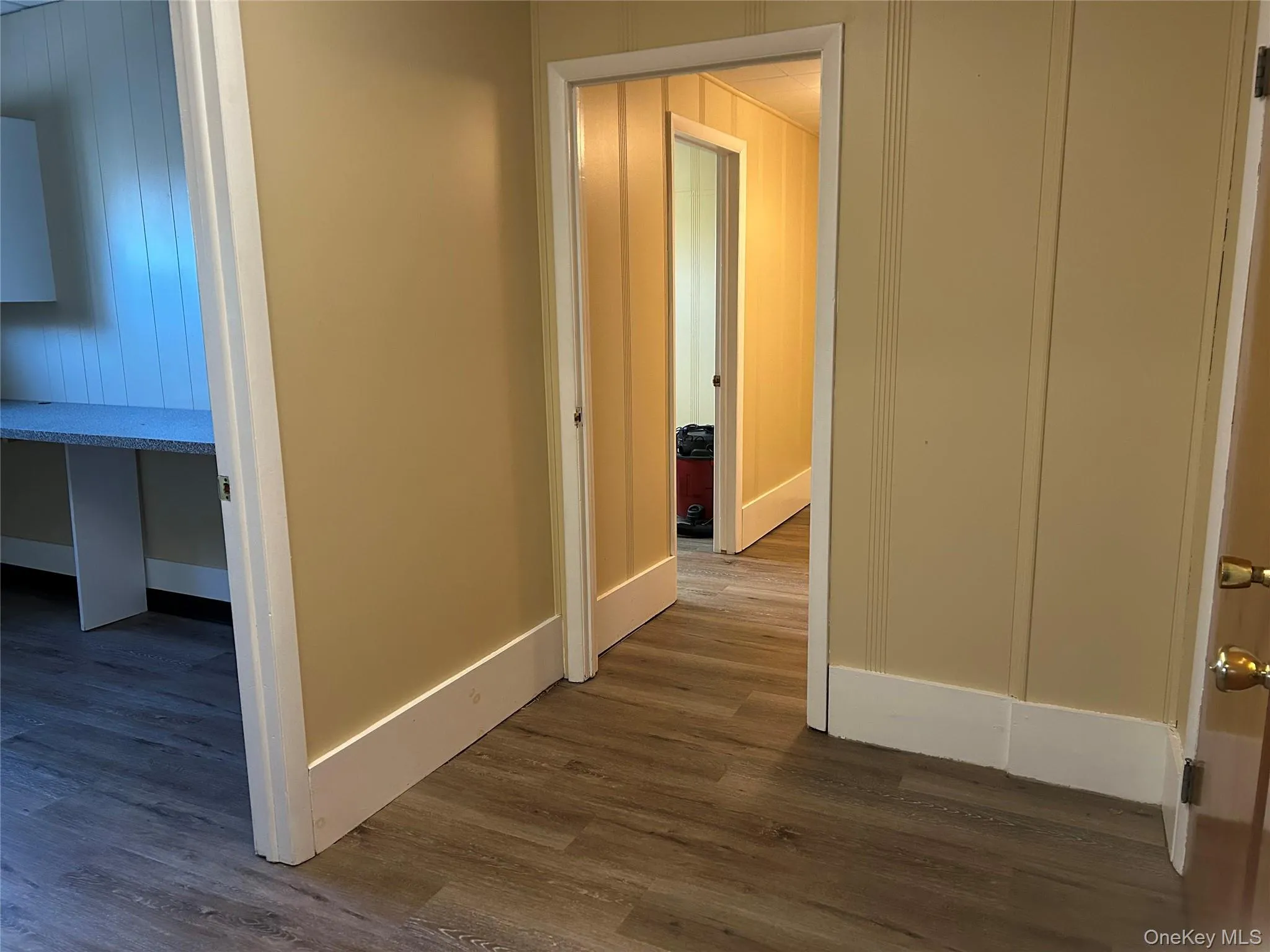 Corridor with dark hardwood / wood-style flooring Corridor with dark hardwood / wood-style flooring