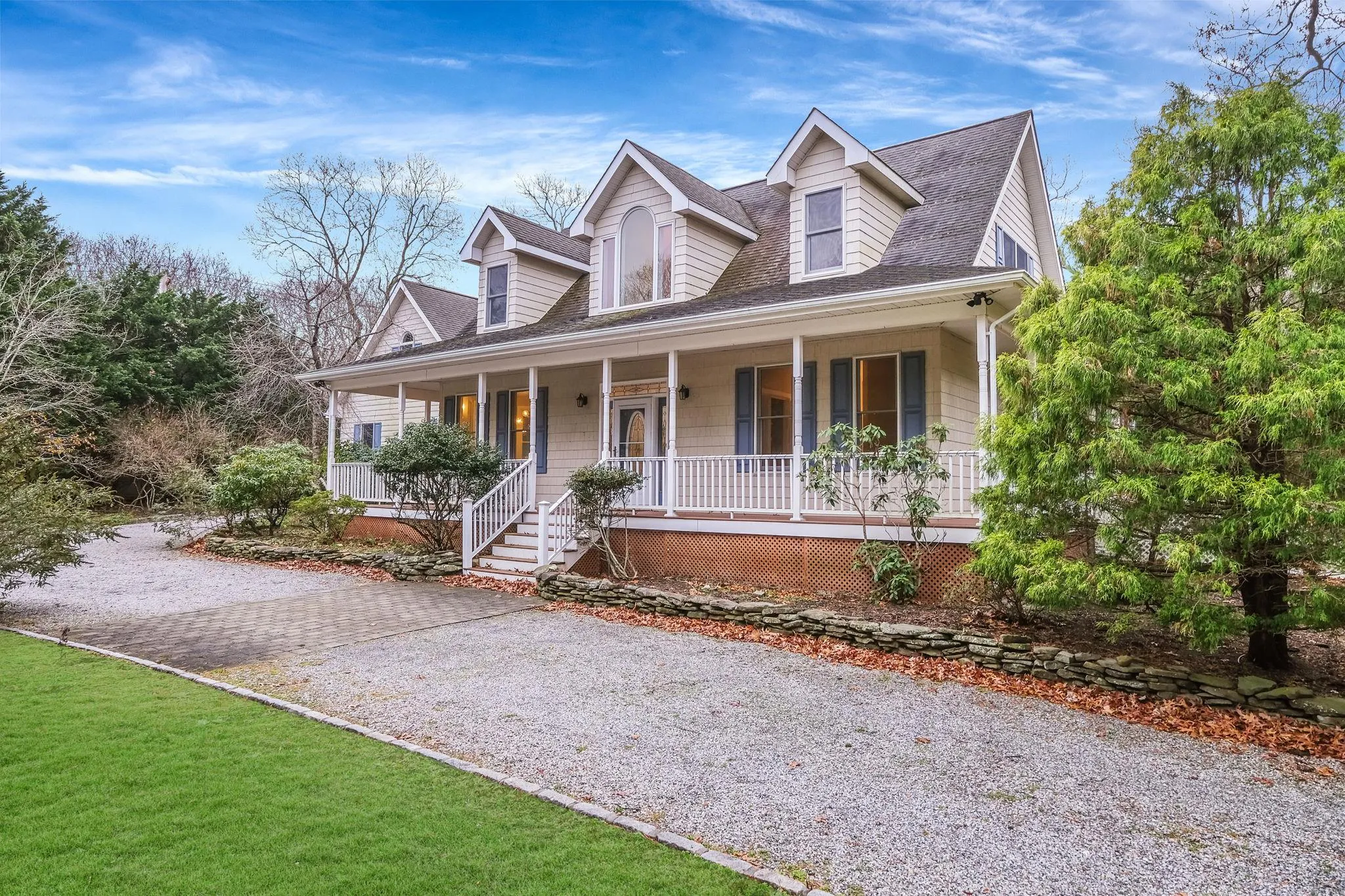 Cape cod-style house featuring covered porch Cape cod-style house featuring covered porch