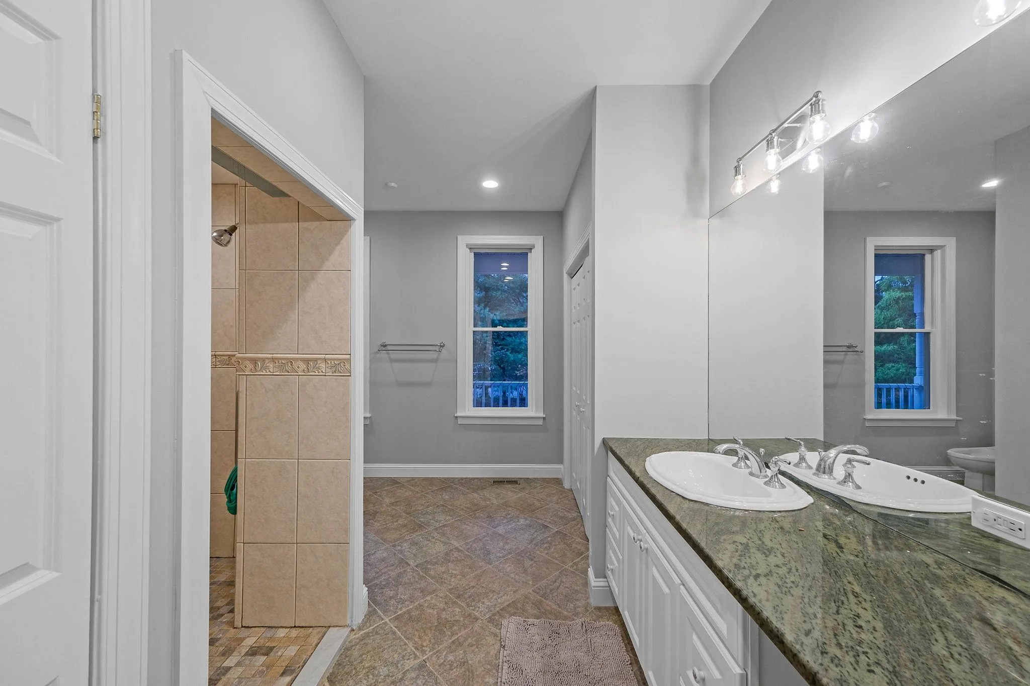 Bathroom with vanity and tiled shower Bathroom with vanity and tiled shower