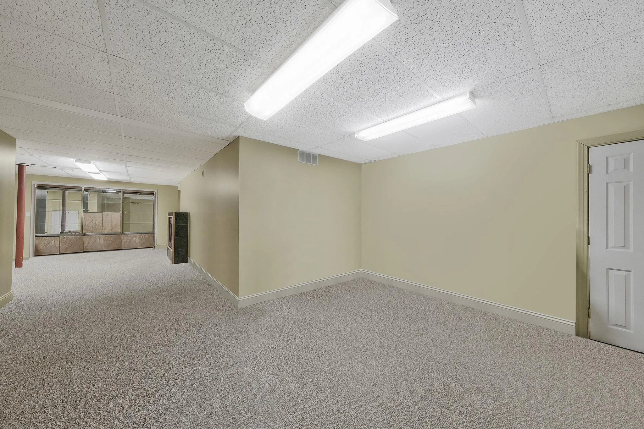 Carpeted empty room with a paneled ceiling Carpeted empty room with a paneled ceiling