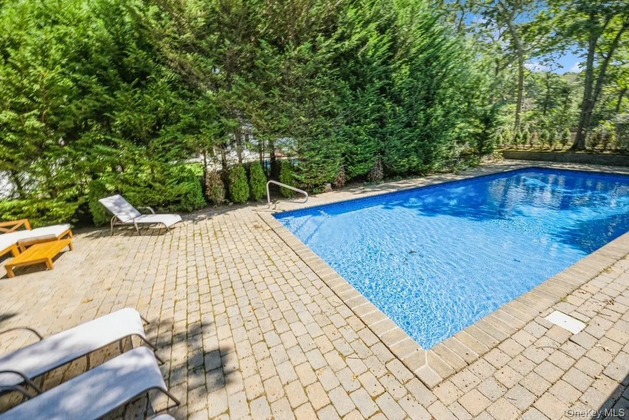 View Of Heated Lap Pool Featuring A Patio Area