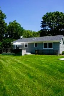 Rear view of property featuring a lawn Rear view of property featuring a lawn