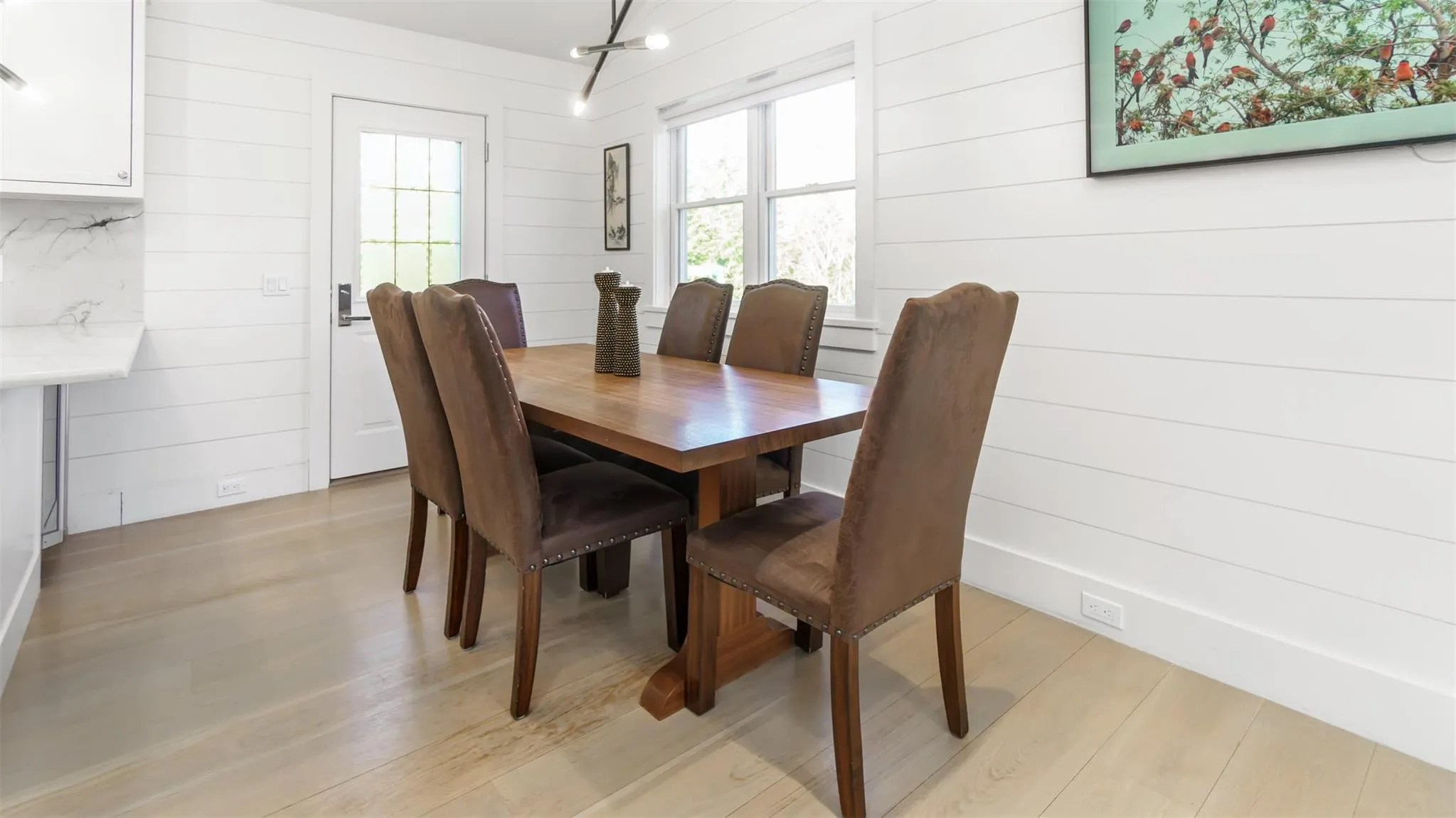 Dining area with plenty of natural light and light wood-type flooring Dining area with plenty of natural light and light wood-type flooring