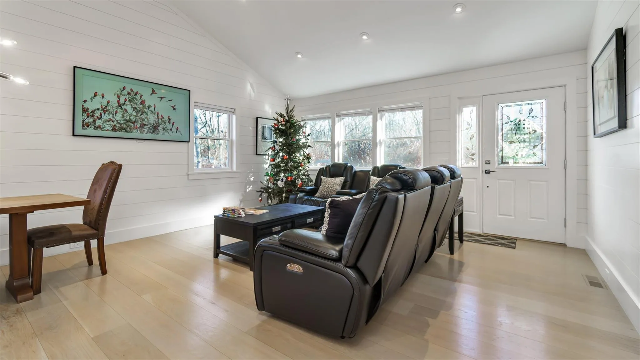 Living room with high vaulted ceiling and light hardwood / wood-style flooring Living room with high vaulted ceiling and light hardwood / wood-style flooring