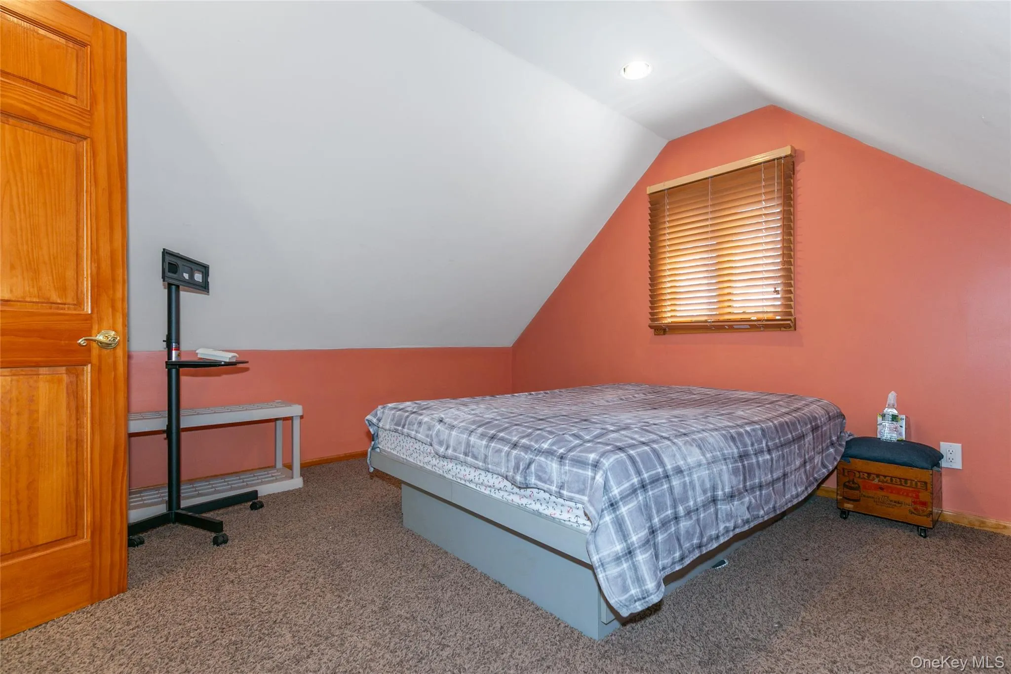 Bedroom featuring carpet floors and vaulted ceiling Bedroom featuring carpet floors and vaulted ceiling