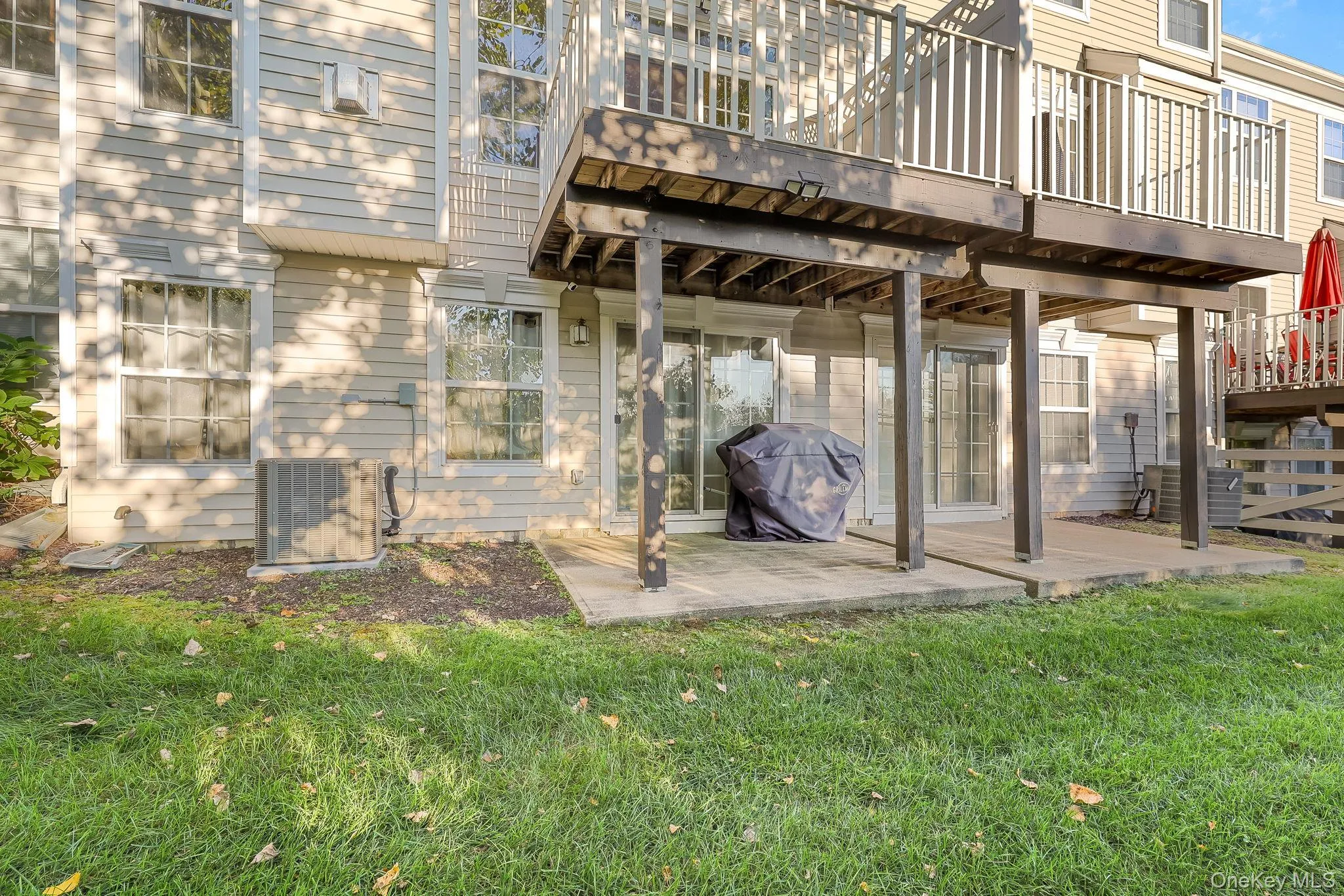 Ground-level patio with direct access to interior spaces through glass sliding doors Ground-level patio with direct access to interior spaces through glass sliding doors