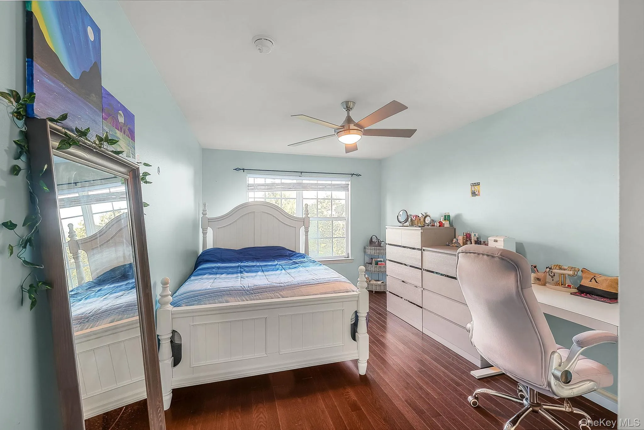 Hardwood flooring, painted walls, ceiling fan with integrated lighting, and a window with blinds Hardwood flooring, painted walls, ceiling fan with integrated lighting, and a window with blinds