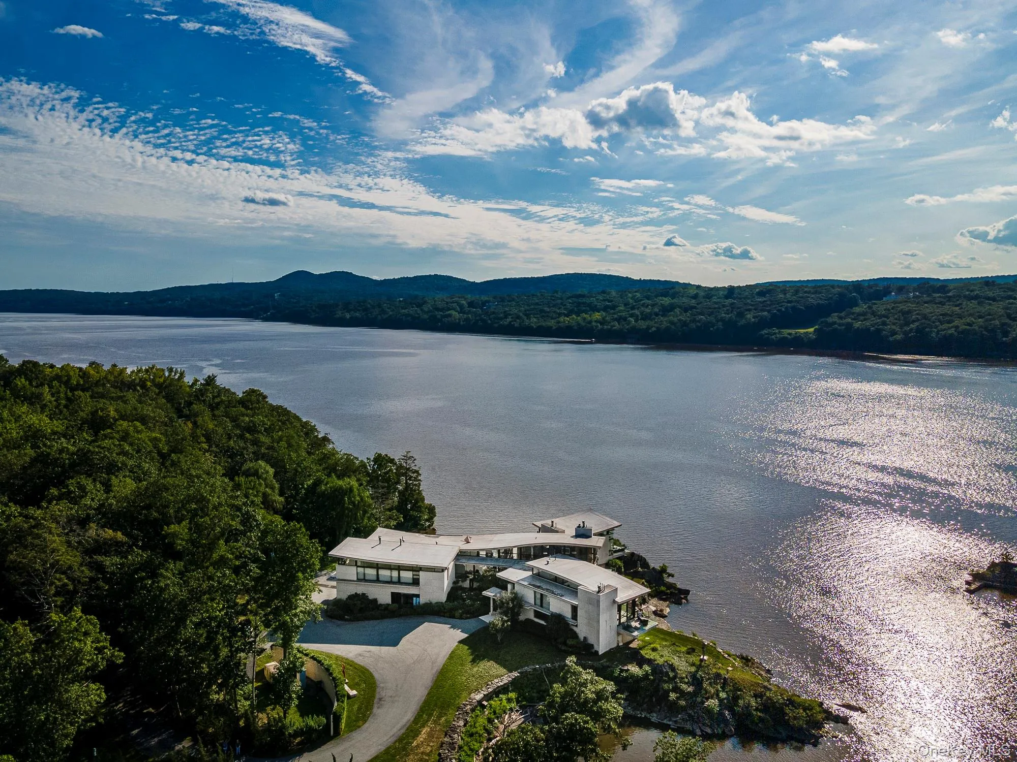Birds eye view of property with a water and mountain view Birds eye view of property with a water and mountain view