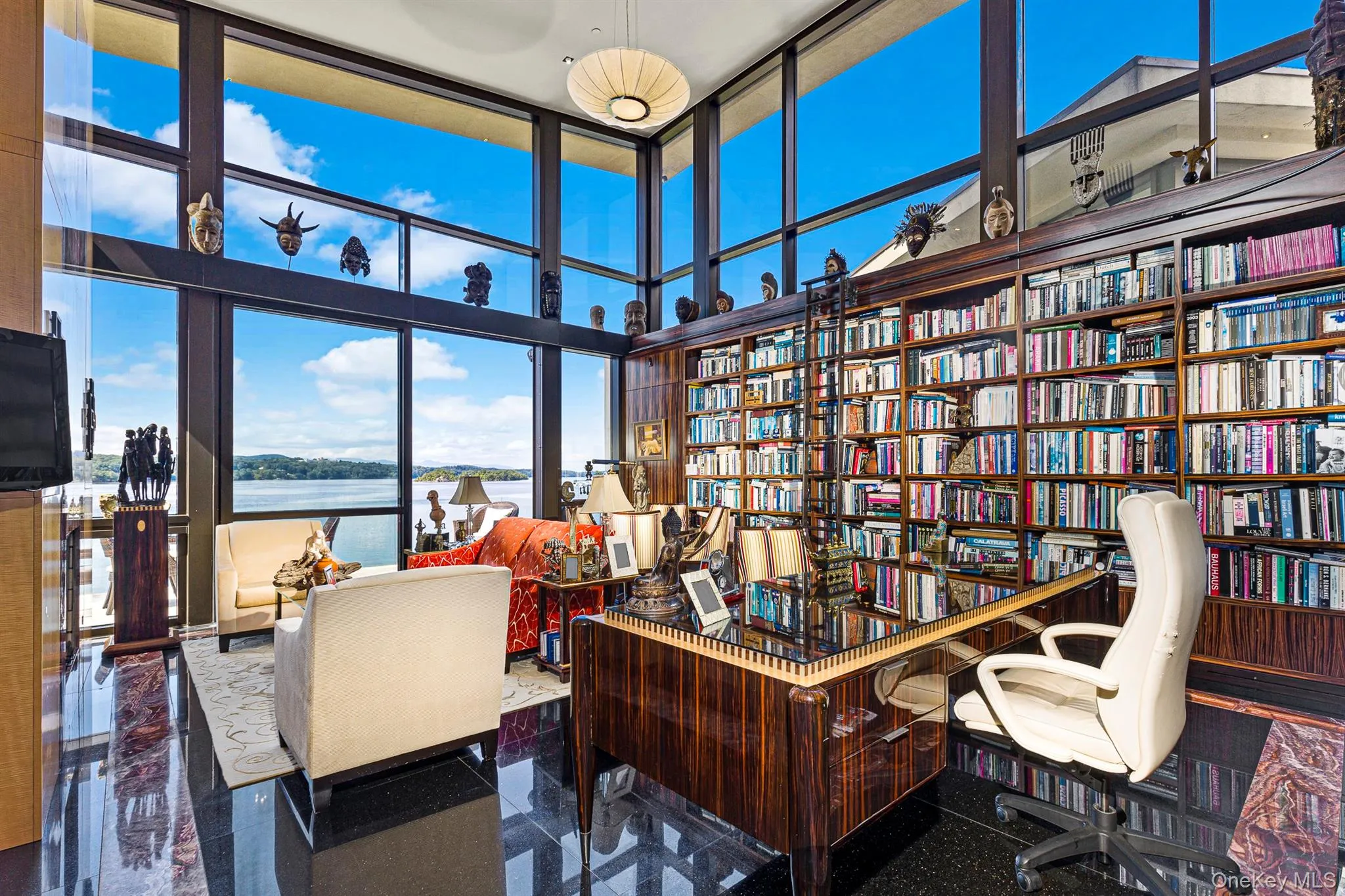 Office with a water view, a wall of windows, and a high ceiling Office with a water view, a wall of windows, and a high ceiling