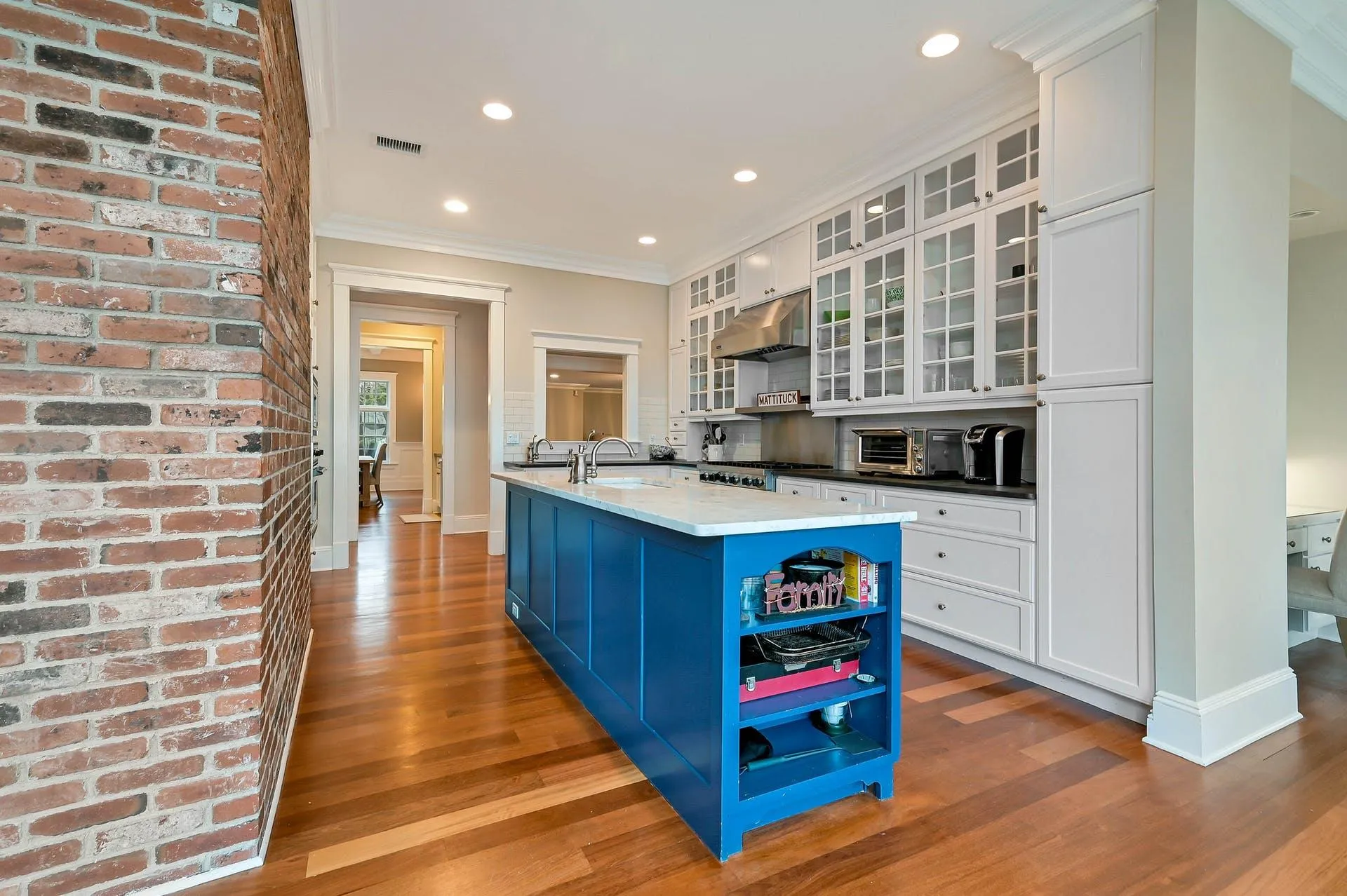 Kitchen featuring sink, blue cabinetry, light hardwood / wood-style flooring, white cabinets, and an island with sink Kitchen featuring sink, blue cabinetry, light hardwood / wood-style flooring, white cabinets, and an island with sink