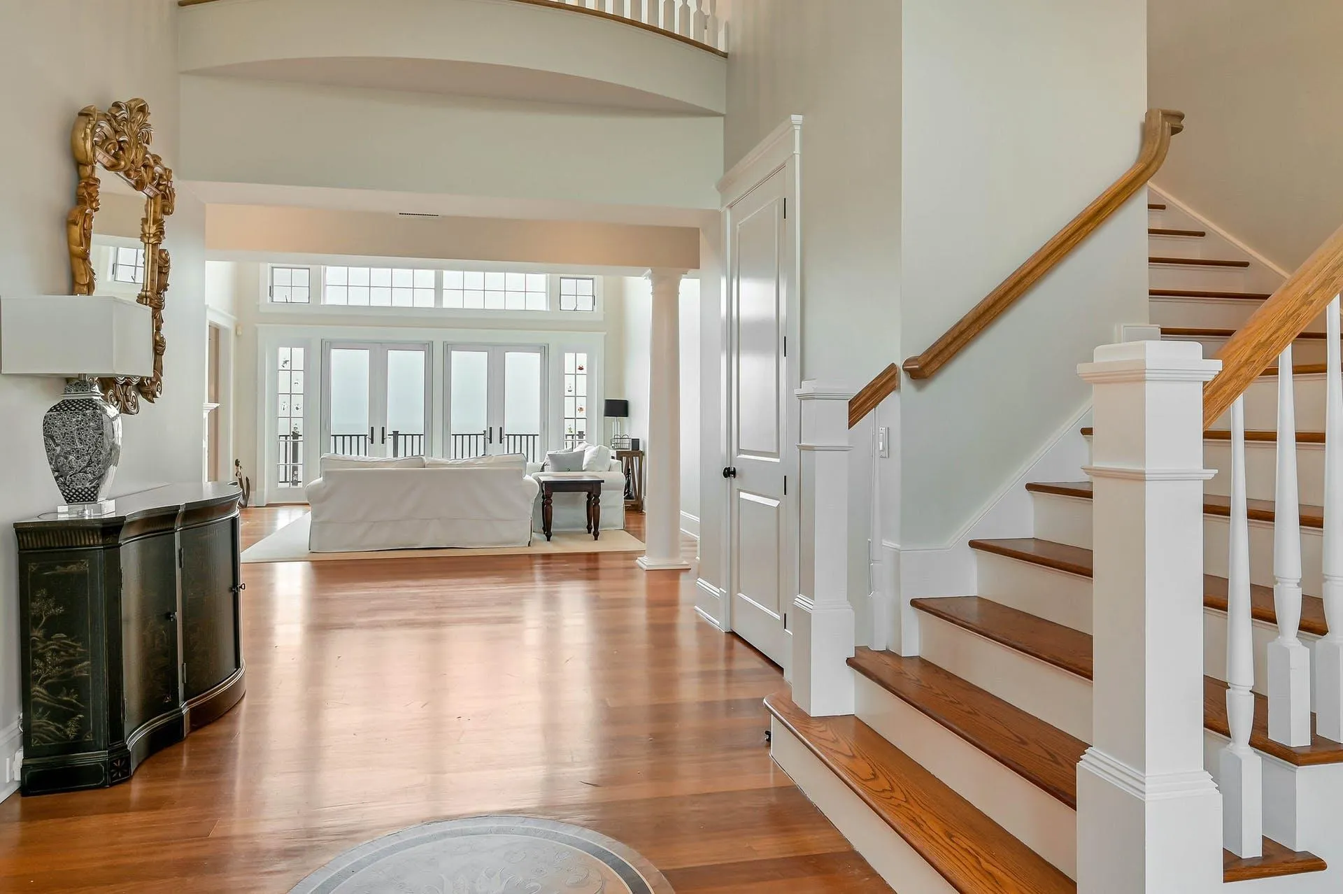 Entryway featuring light hardwood / wood-style flooring and a high ceiling Entryway featuring light hardwood / wood-style flooring and a high ceiling
