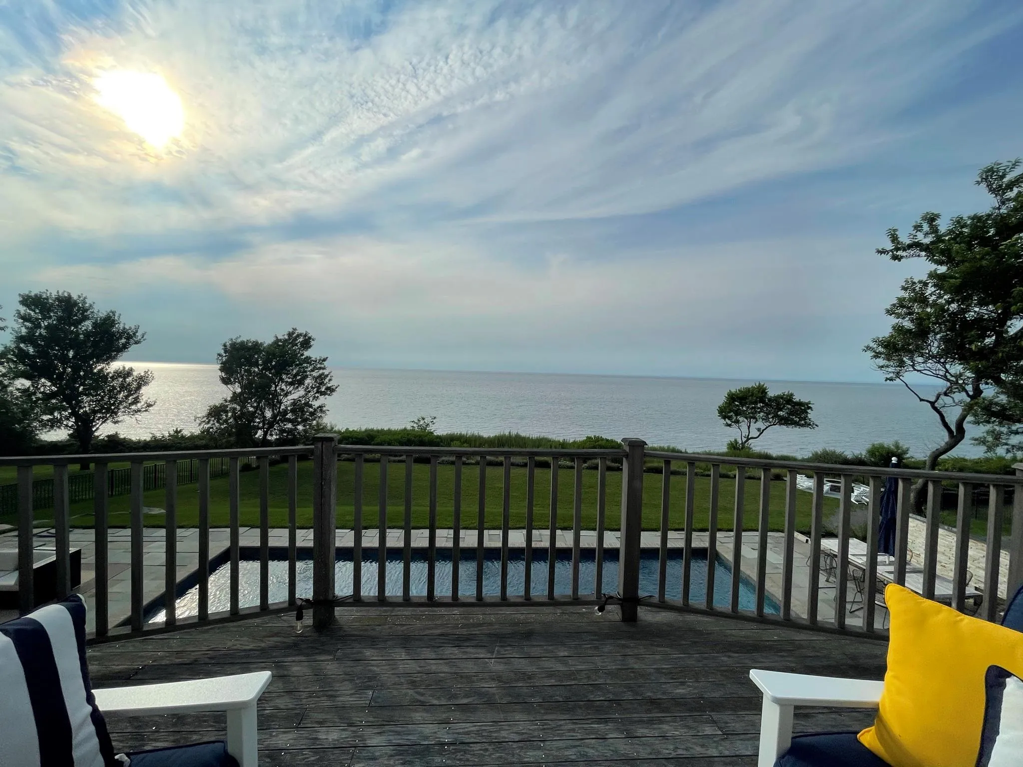 Deck featuring a water view and a lawn Deck featuring a water view and a lawn