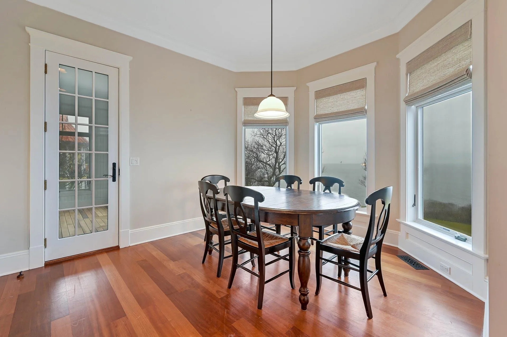 Dining area featuring hardwood / wood-style floors and ornamental molding Dining area featuring hardwood / wood-style floors and ornamental molding