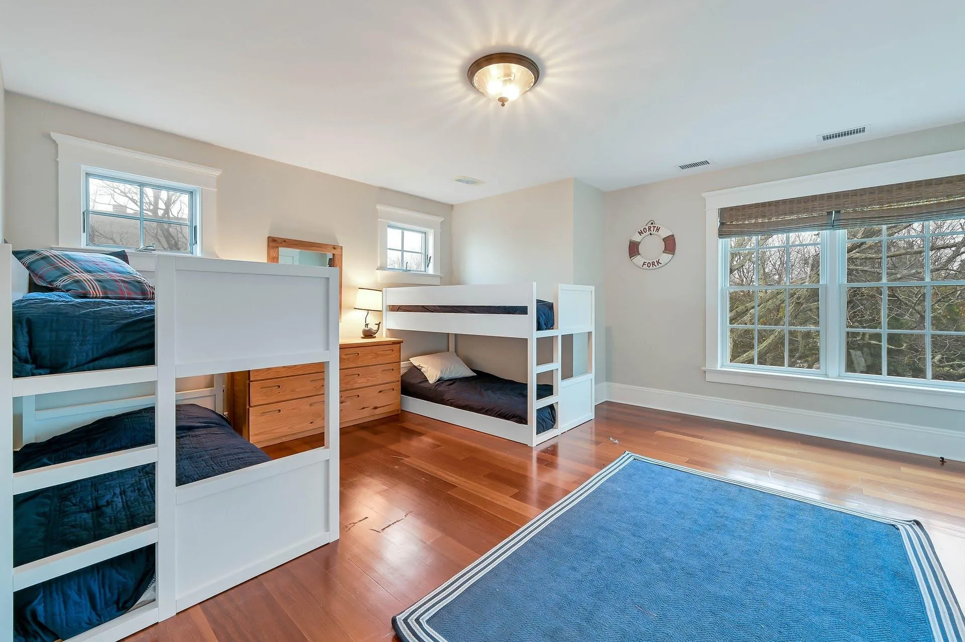 Bedroom with multiple windows and hardwood / wood-style floors Bedroom with multiple windows and hardwood / wood-style floors