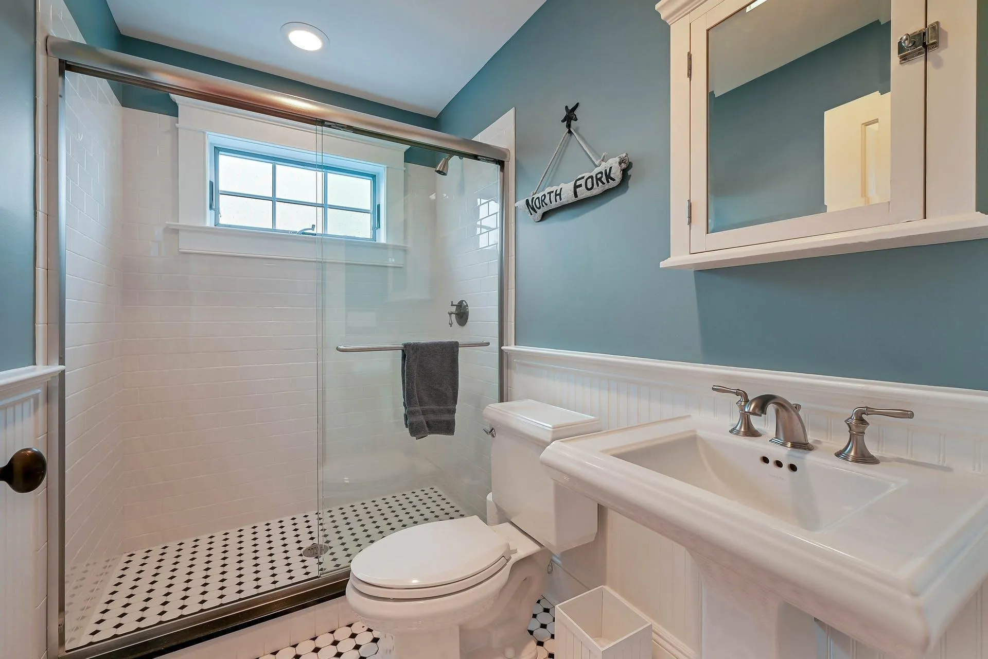 Bathroom featuring tile patterned floors, toilet, sink, and walk in shower Bathroom featuring tile patterned floors, toilet, sink, and walk in shower