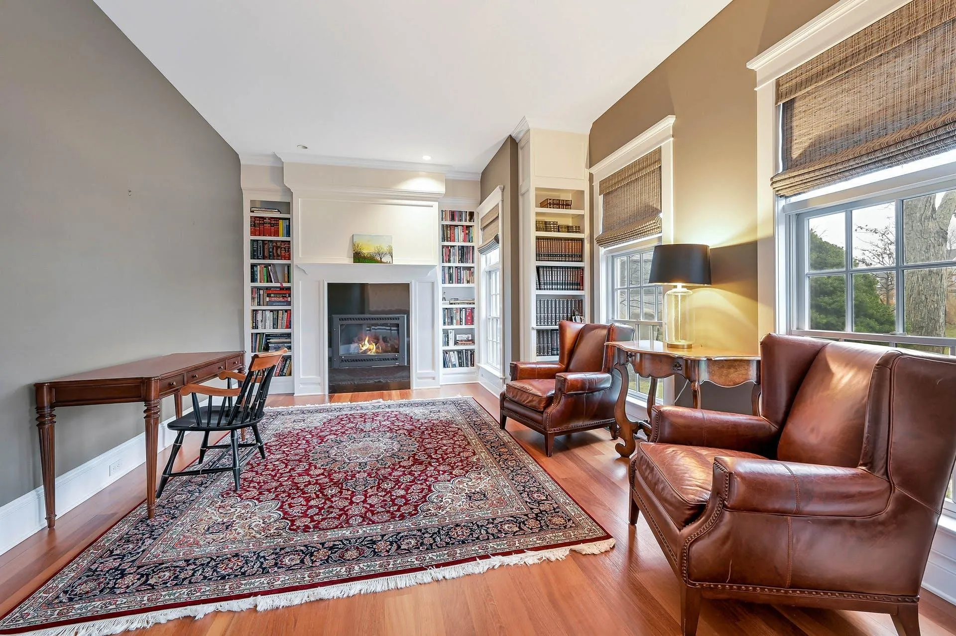 Living room with built in shelves and hardwood / wood-style flooring Living room with built in shelves and hardwood / wood-style flooring
