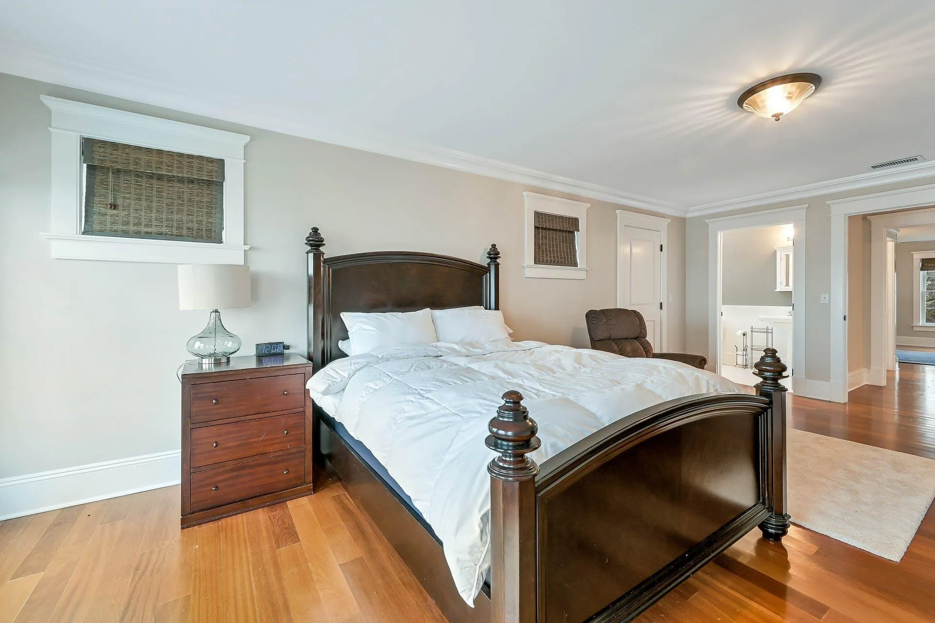 Bedroom with ornamental molding and light wood-type flooring Bedroom with ornamental molding and light wood-type flooring