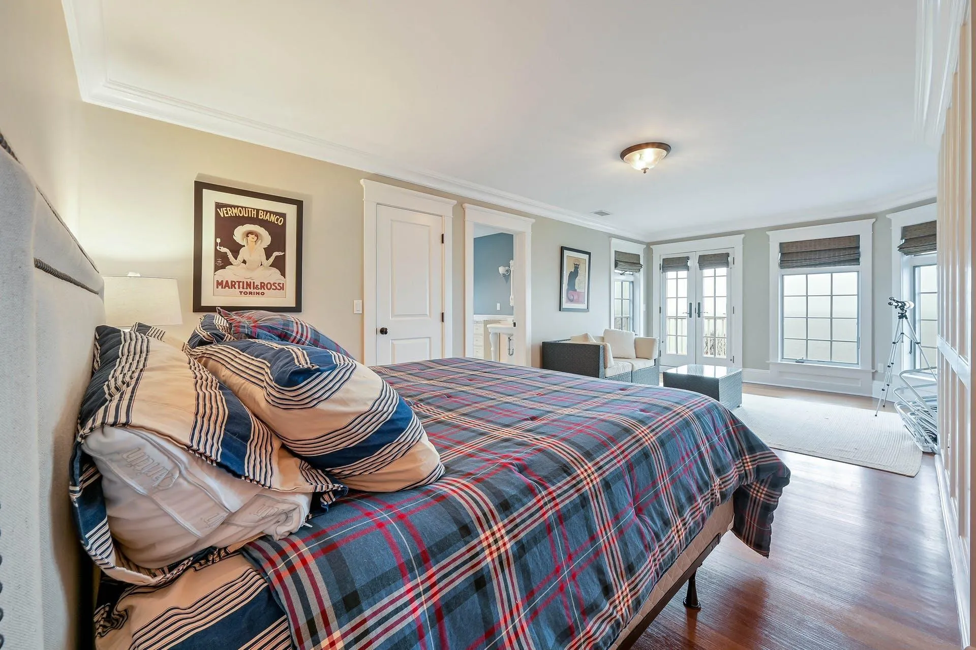 Bedroom featuring connected bathroom, french doors, hardwood / wood-style floors, and ornamental molding Bedroom featuring connected bathroom, french doors, hardwood / wood-style floors, and ornamental molding