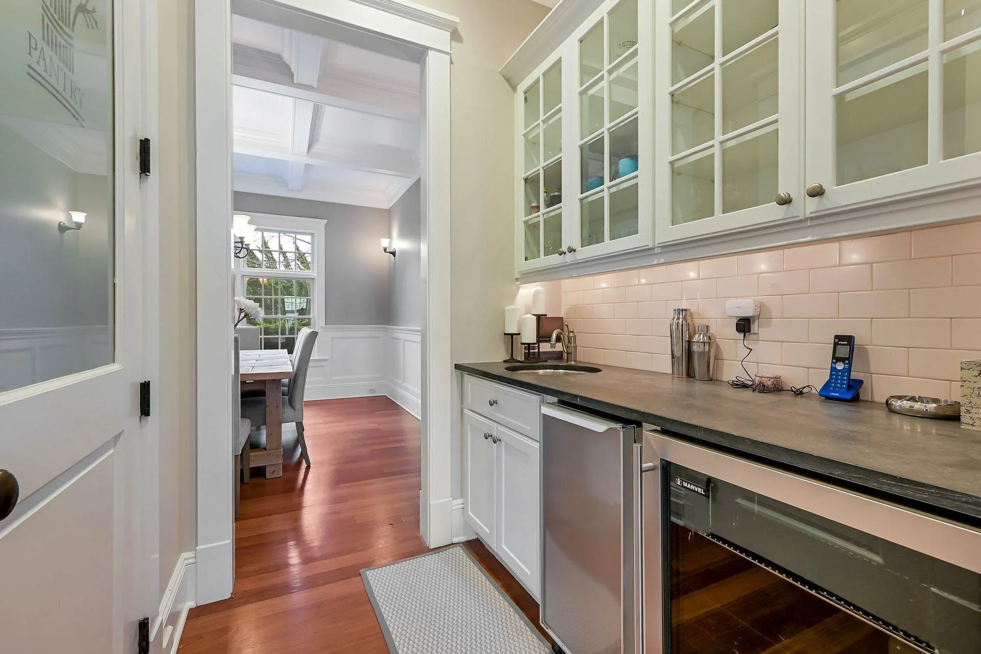 Bar featuring coffered ceiling, sink, beam ceiling, white cabinets, and wine cooler Bar featuring coffered ceiling, sink, beam ceiling, white cabinets, and wine cooler