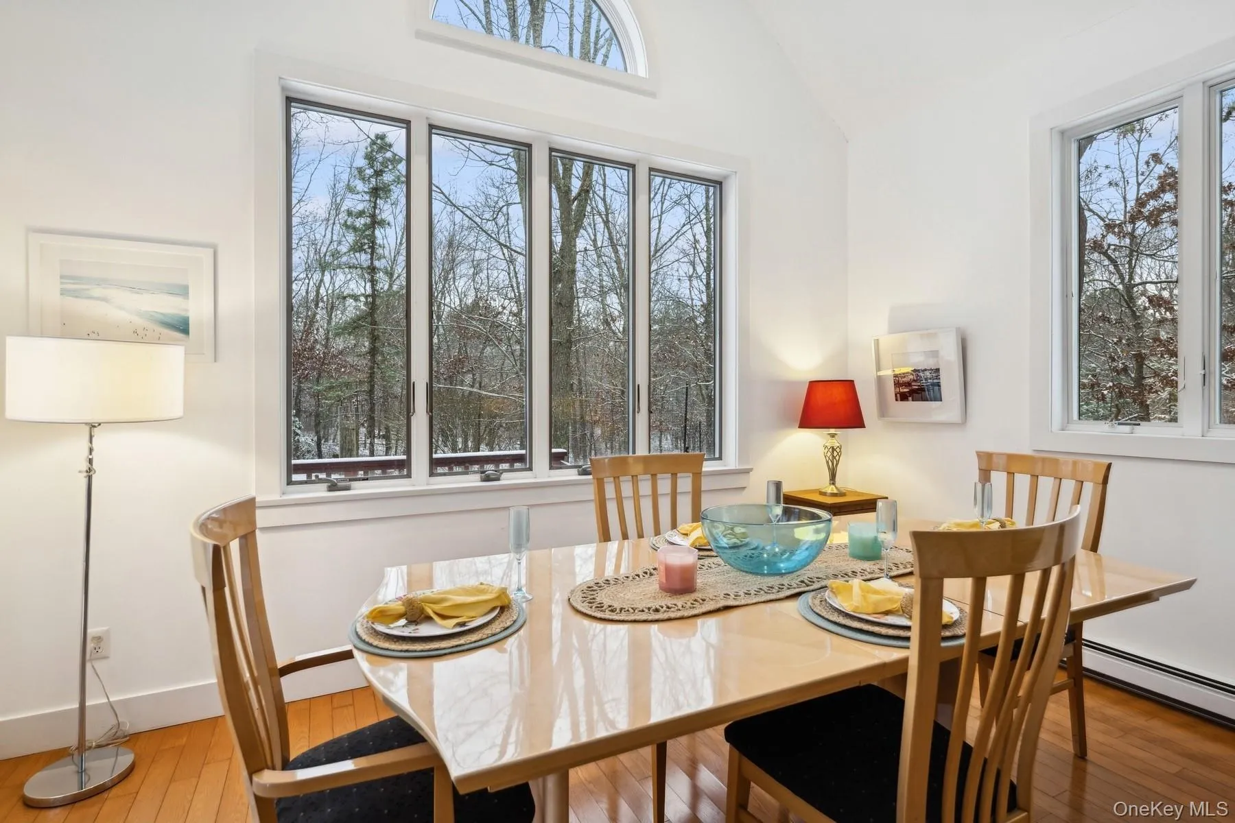Dining area with baseboard heating, vaulted ceiling, and hardwood / wood-style flooring Dining area with baseboard heating, vaulted ceiling, and hardwood / wood-style flooring