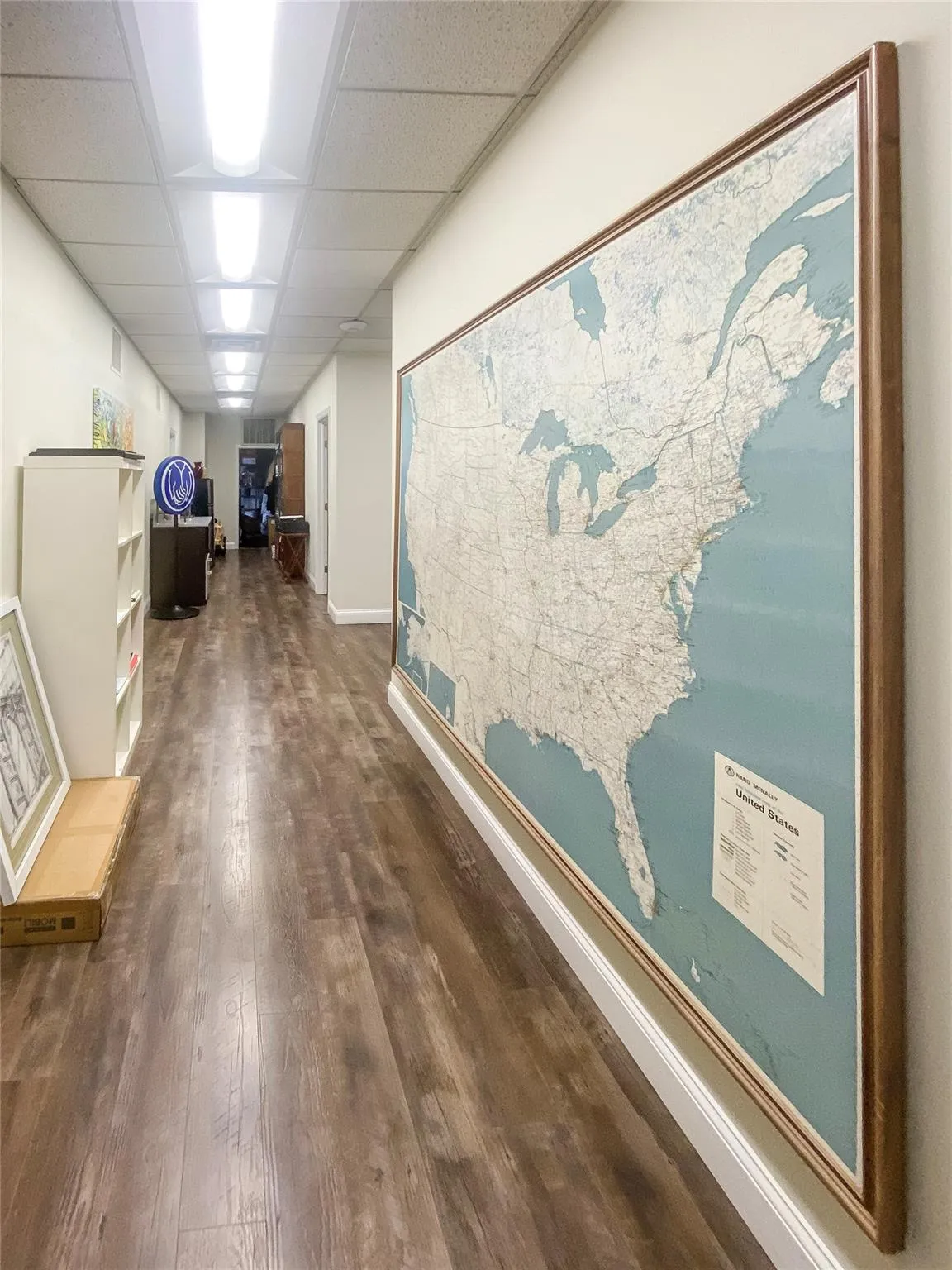 Corridor featuring a paneled ceiling and dark hardwood / wood-style flooring Corridor featuring a paneled ceiling and dark hardwood / wood-style flooring