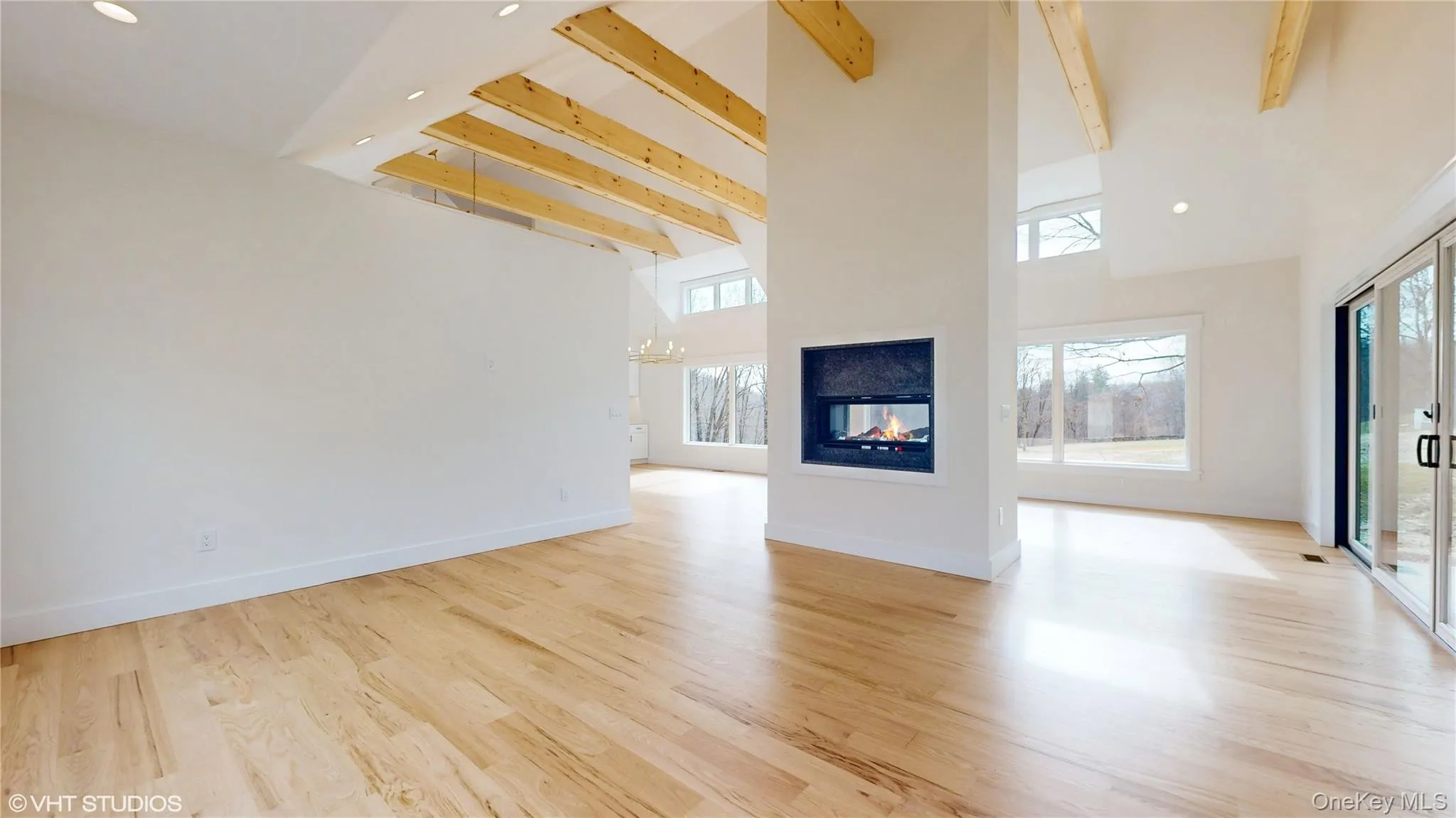 living room featuring beamed ceiling, light hardwood / wood-style floors living room featuring beamed ceiling, light hardwood / wood-style floors